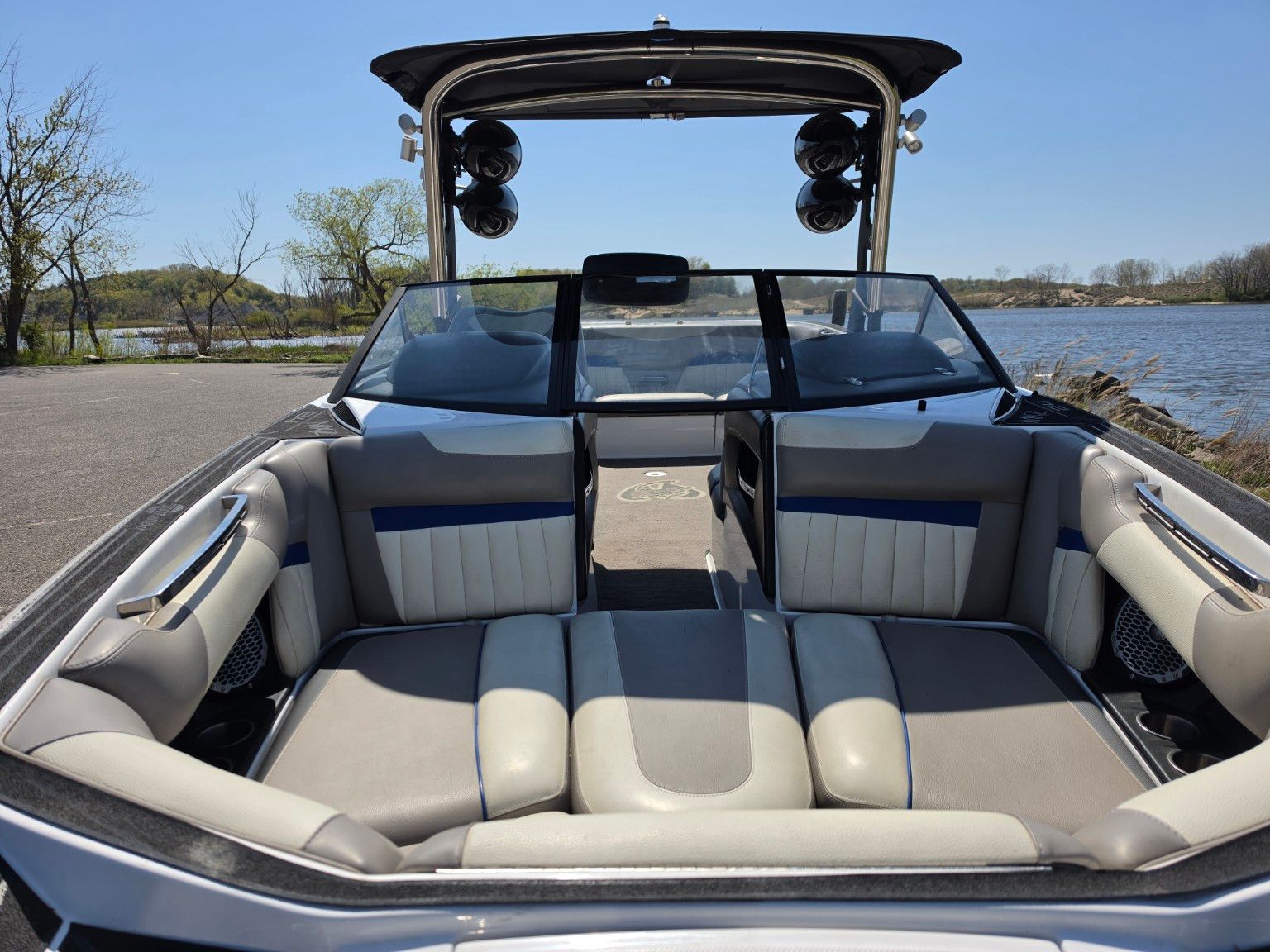 Interior of a 2014 Malibu Wakesetter 24 MXZ boat by the water.