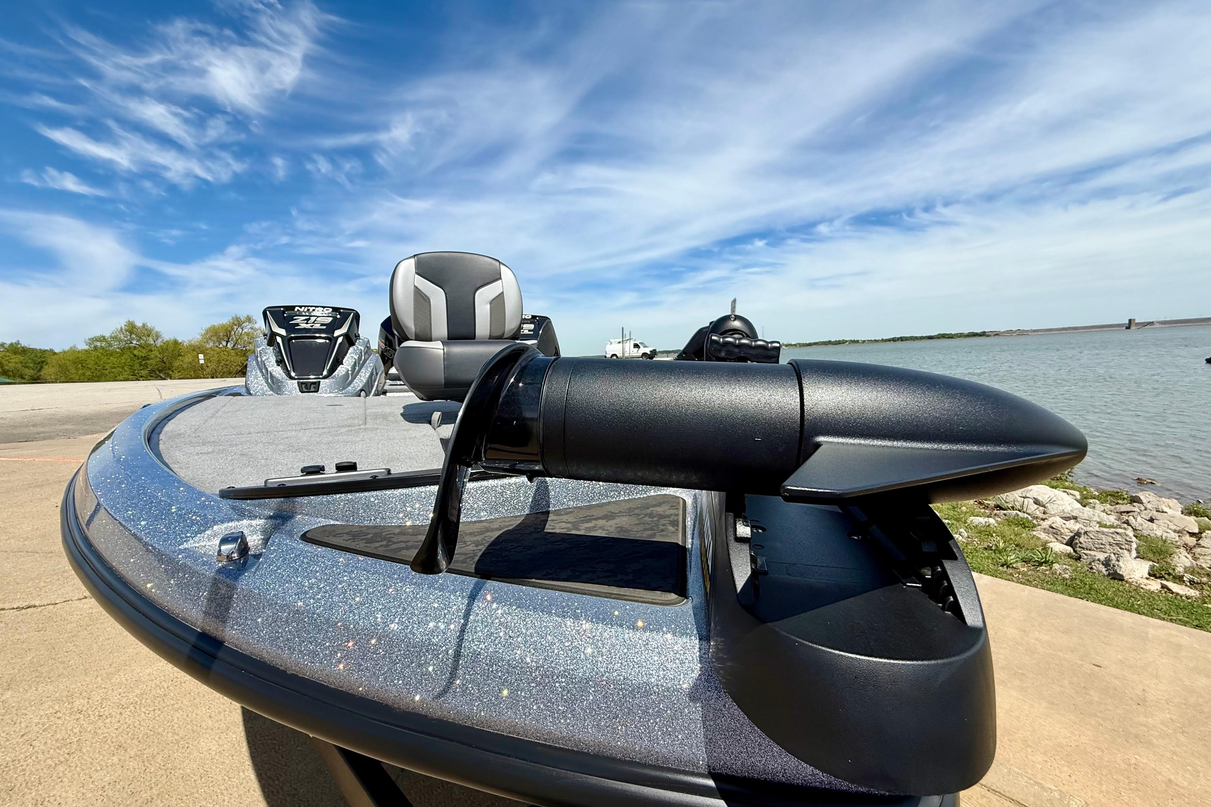 2026 Nitro Z19 XL boat by the lake, featuring sleek design and modern seating.