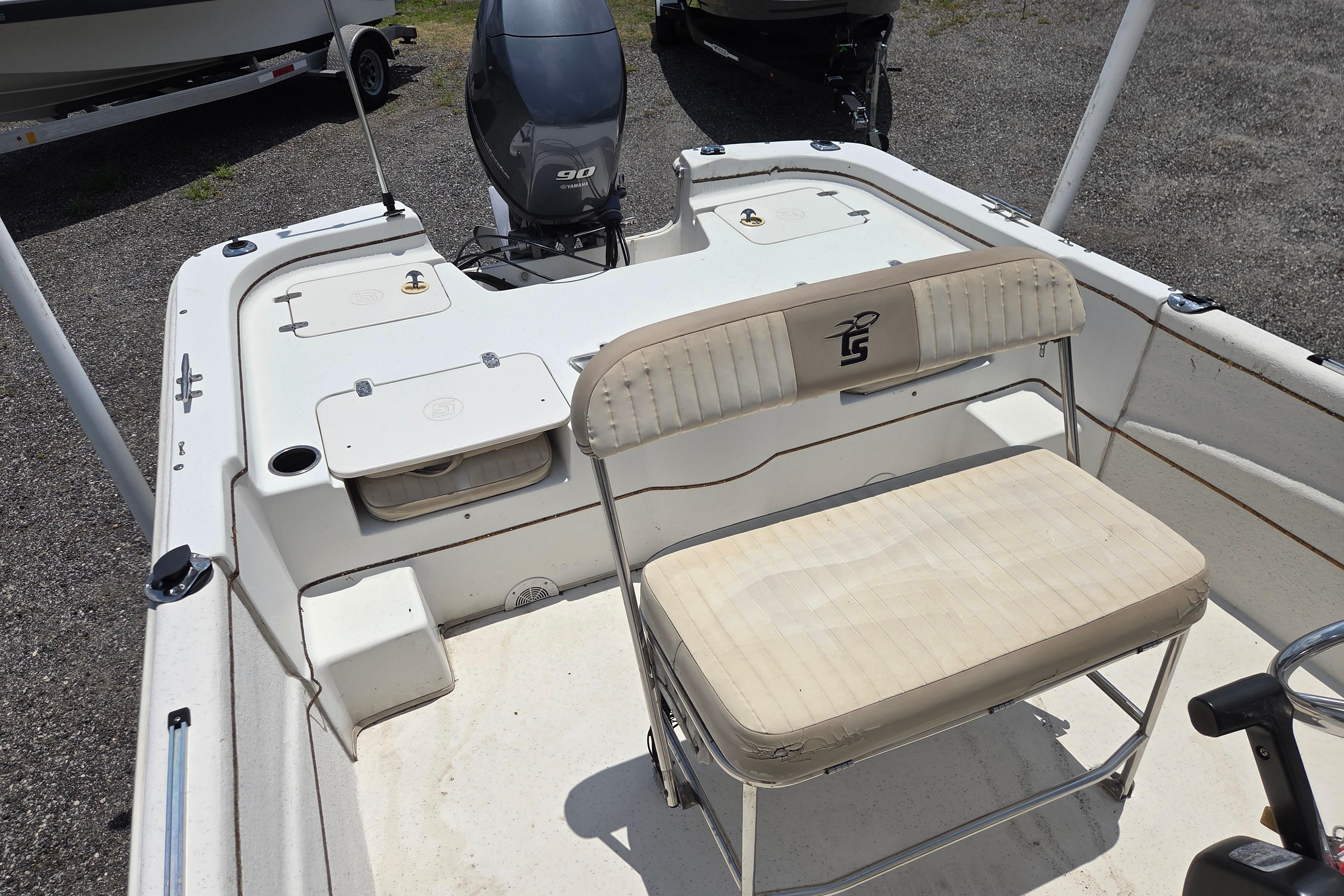 2016 Carolina Skiff 198 DLV boat interior with seating and outboard motor.