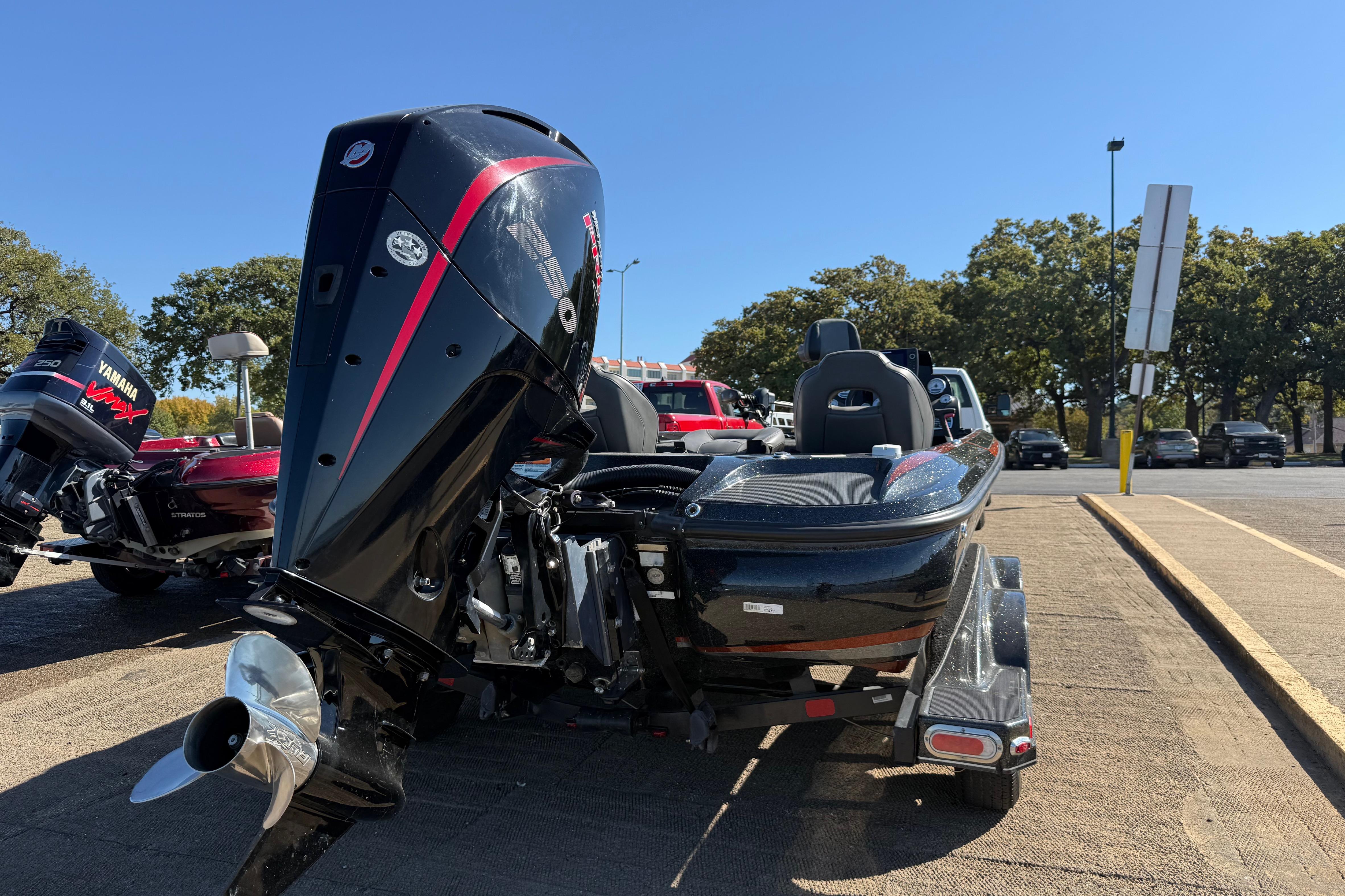 2019 Nitro Z21 Pro boat with powerful outboard motor in parking lot.