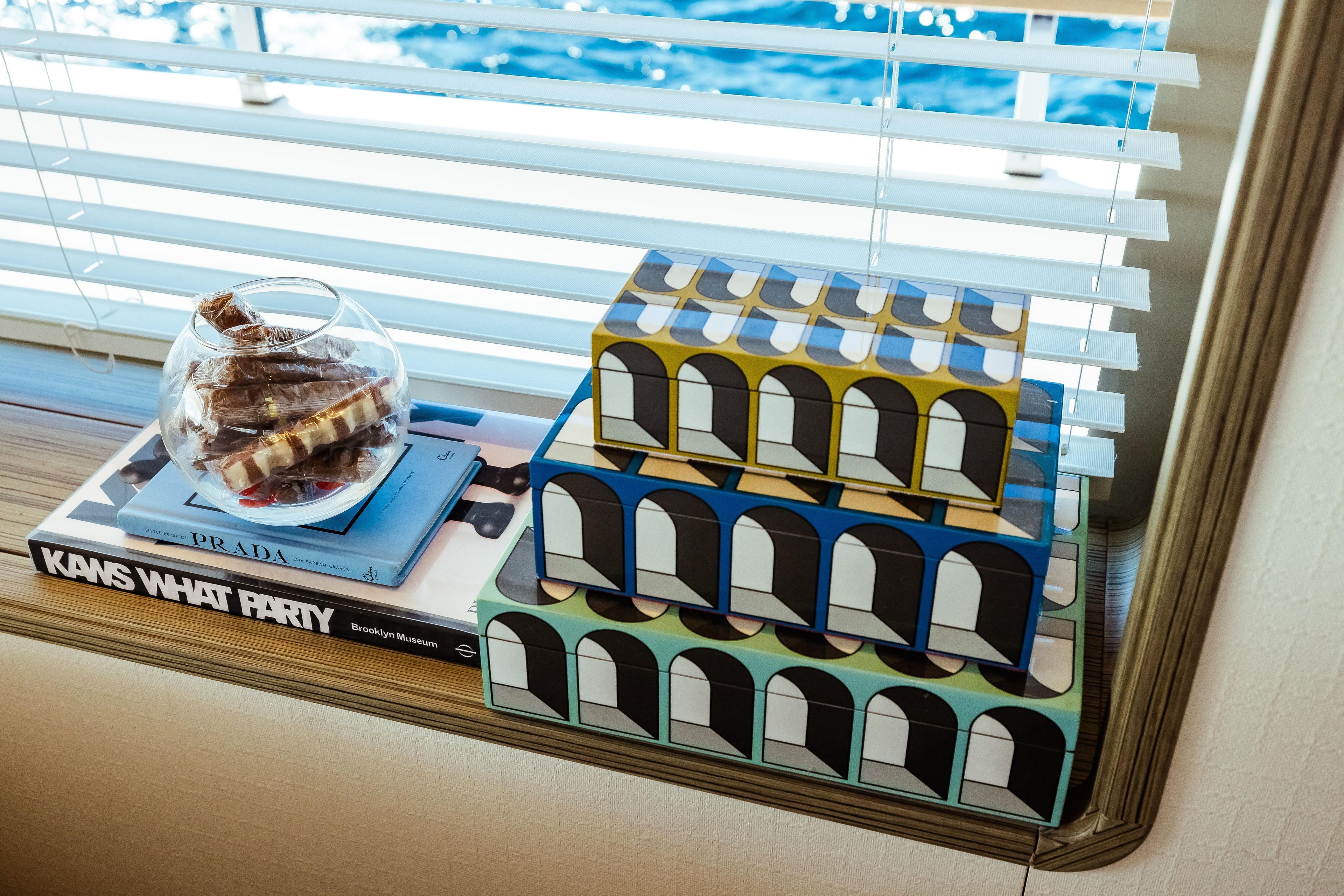 Decorative boxes and books on Custom Line Navetta 30 yacht, 2022, with ocean view.