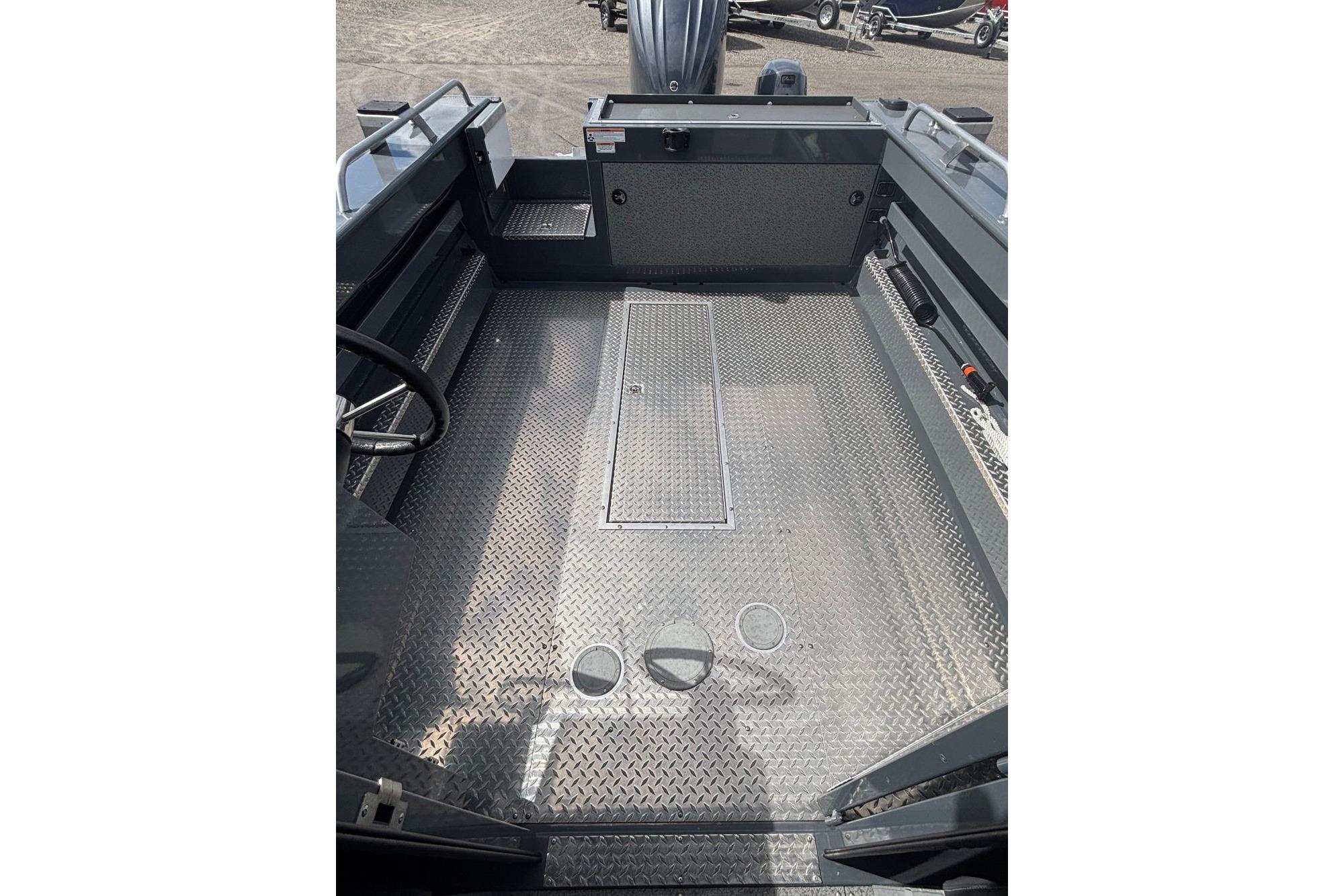 2024 Hewescraft 240 Ocean Pro Hardtop interior with diamond plate flooring and steering wheel.
