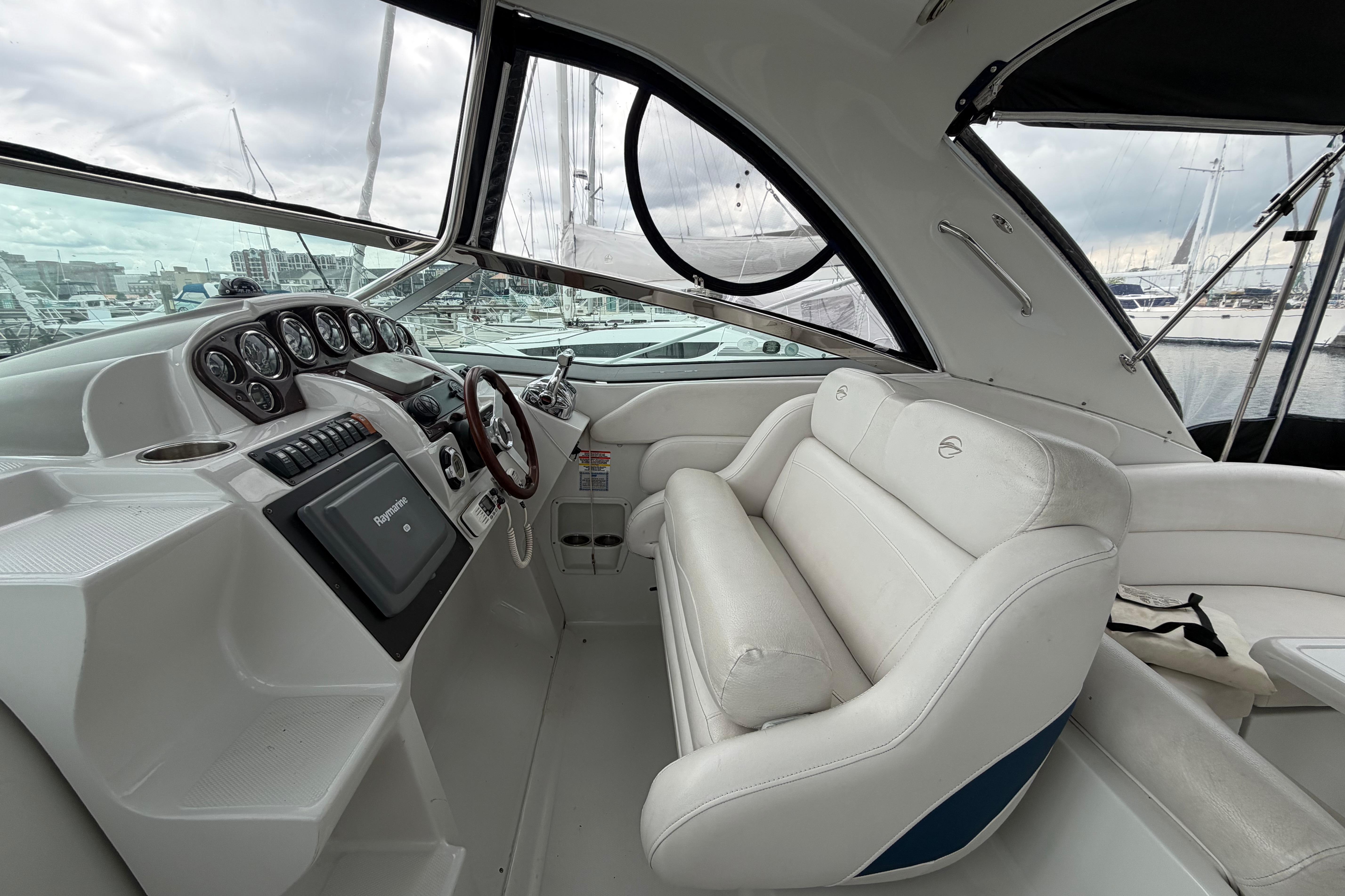 2008 Crownline 340 CR boat interior with white seating and control panel at marina.
