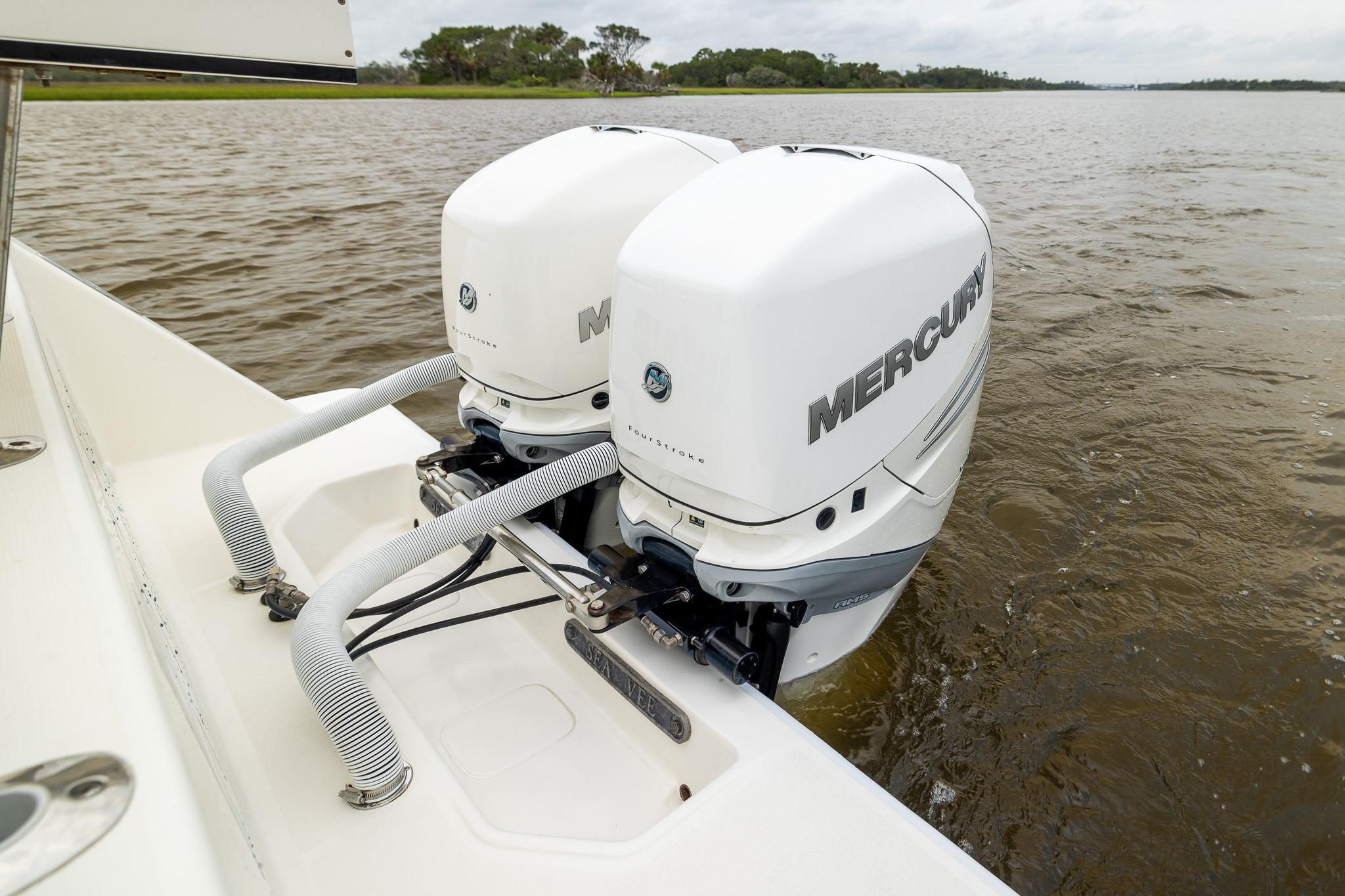 2019 SeaVee 322Z boat with dual Mercury outboard engines on a calm waterway.