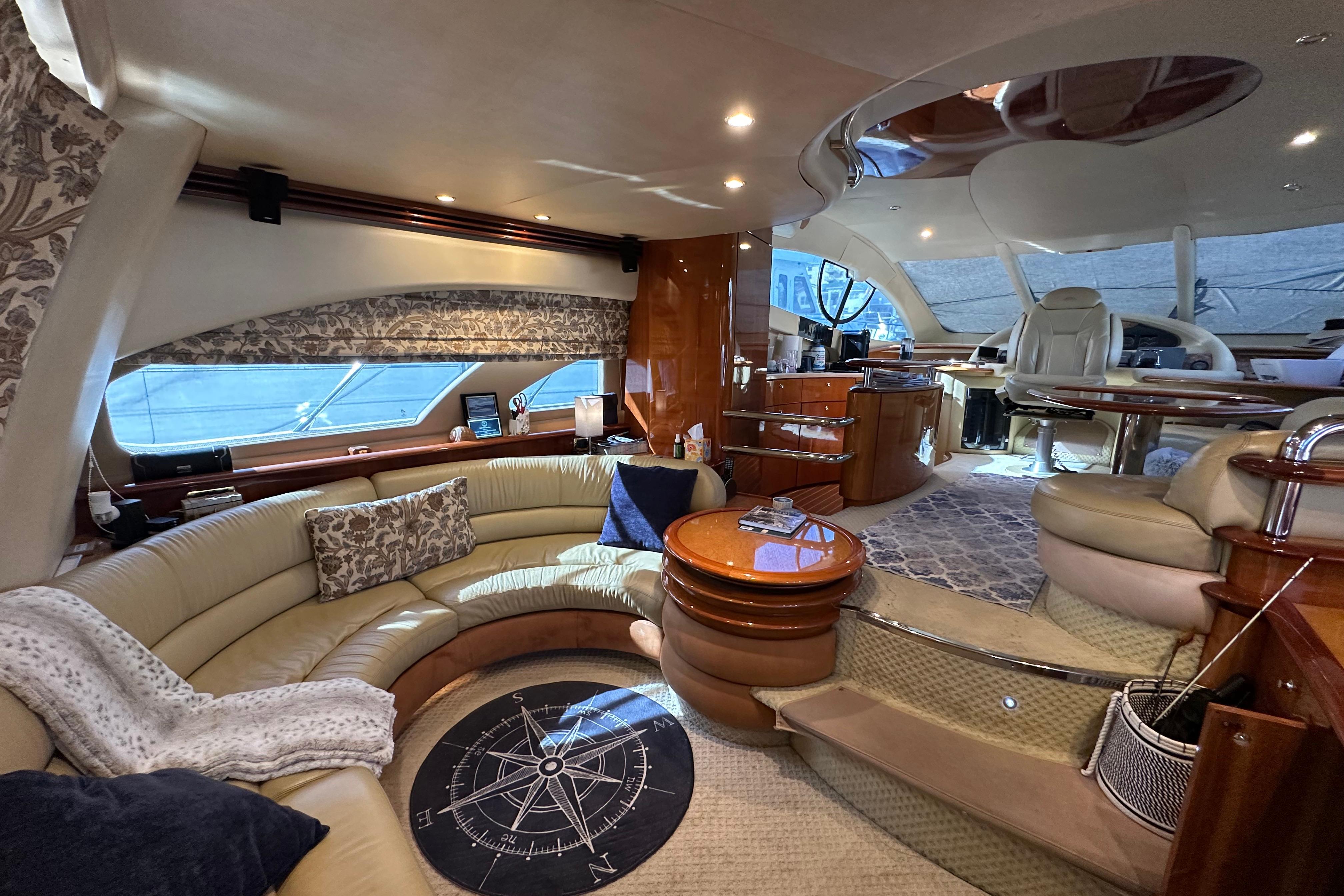 Luxurious interior of a 2004 Azimut 55E yacht with elegant seating and modern amenities.