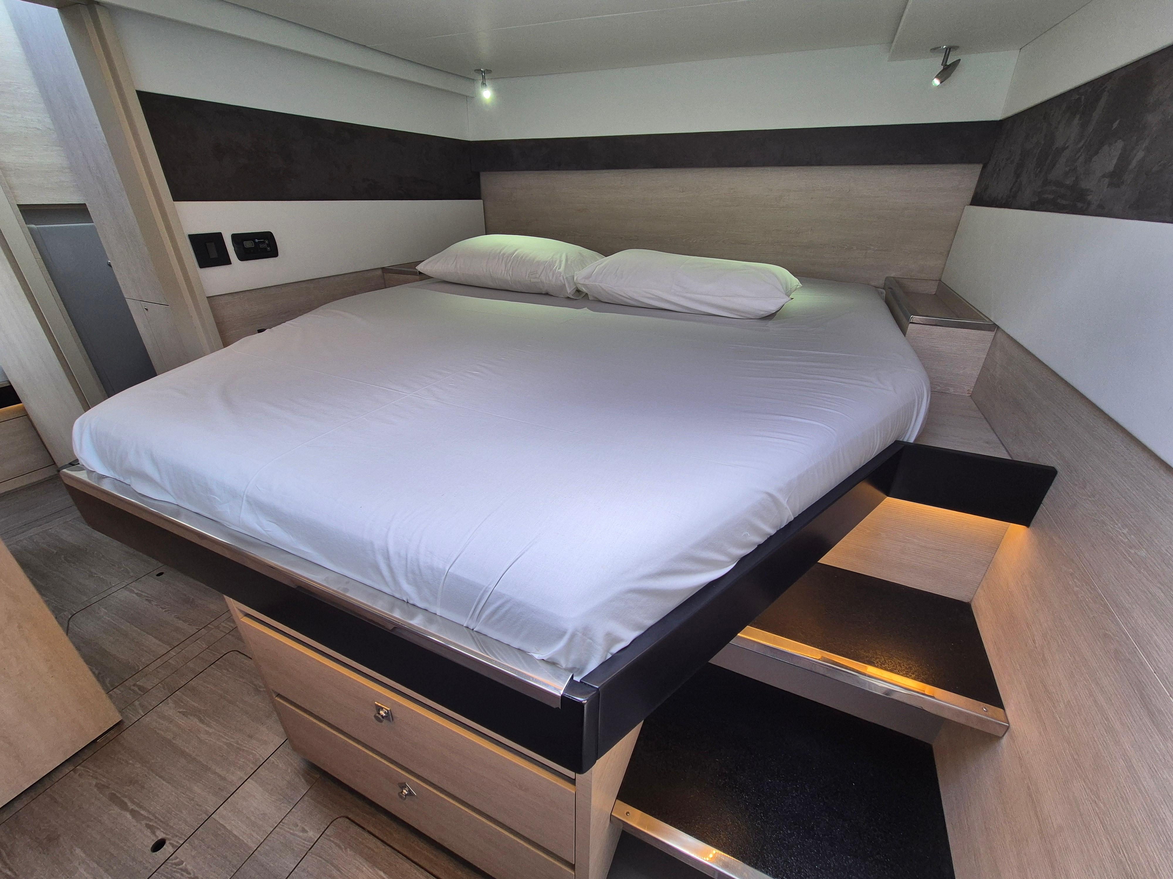 Luxurious bedroom interior in a 2020 Leopard 50 yacht, featuring a cozy bed and modern design.