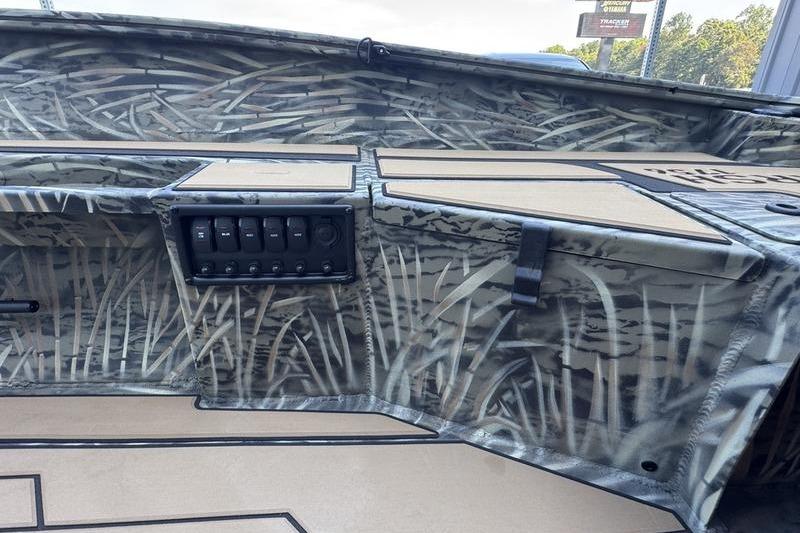 2026 Tracker Grizzly 1756 T Marsh boat interior with camo design and control panel.