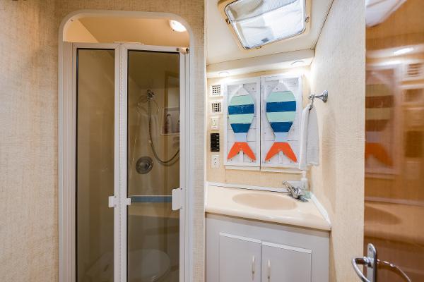 Bathroom interior of 1999 Viking 47 Convertible yacht with shower and sink.