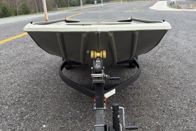 2026 Tracker Grizzly 1754 Utility boat on trailer, parked on asphalt road.