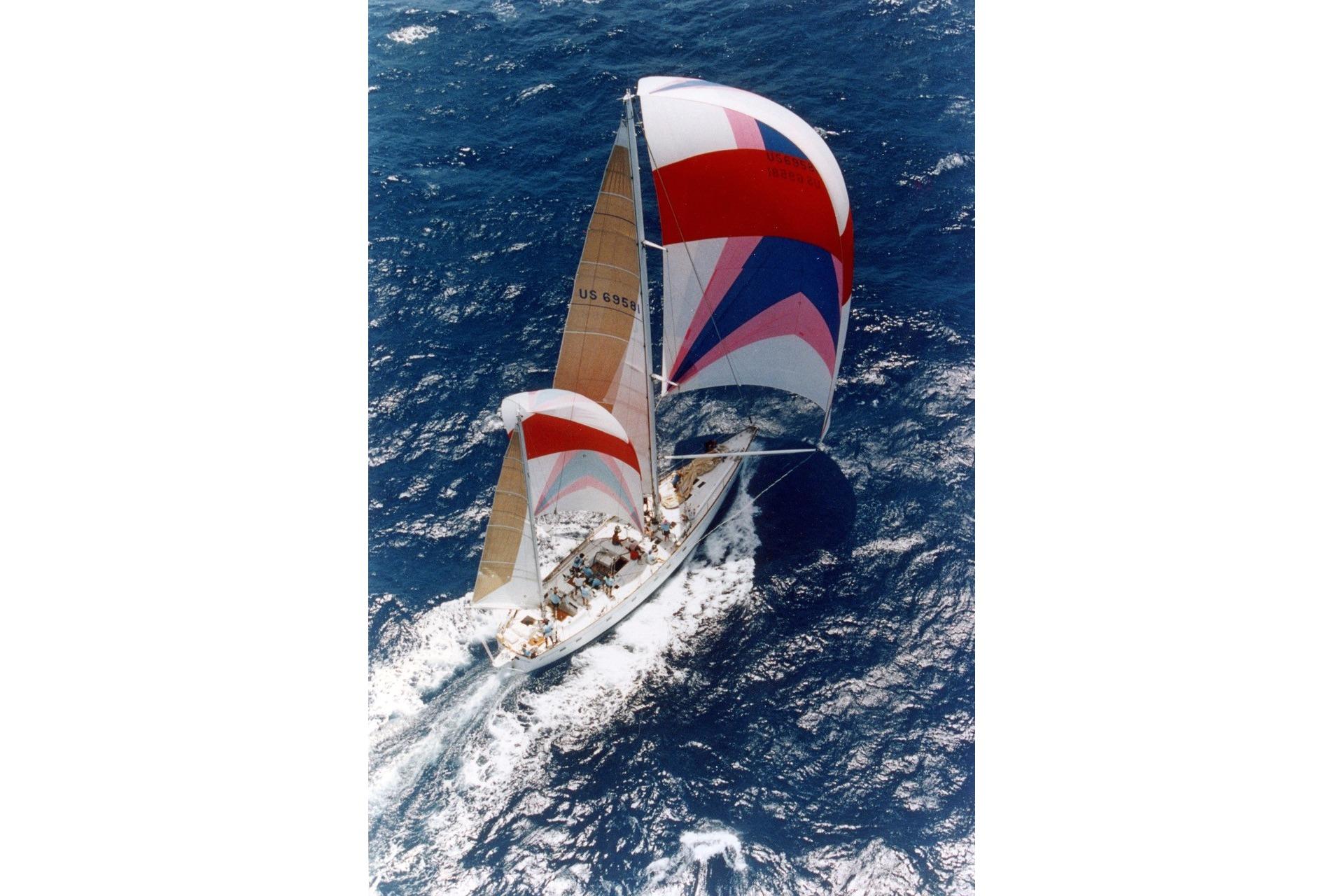 Sailing yacht Abeking & Rasmussen Tripp 74, 1968, navigating ocean waters with colorful sails.