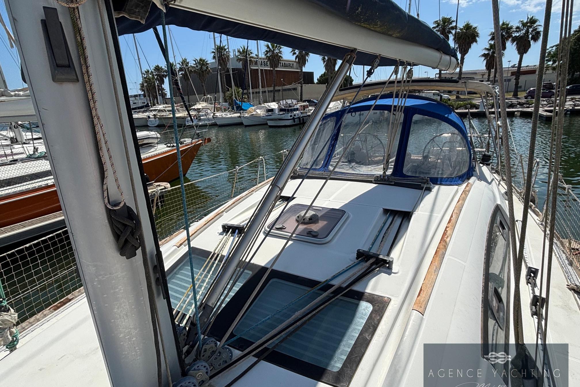 2008 Beneteau Oceanis 40 sailboat docked at marina, featuring sleek design and blue canopy.