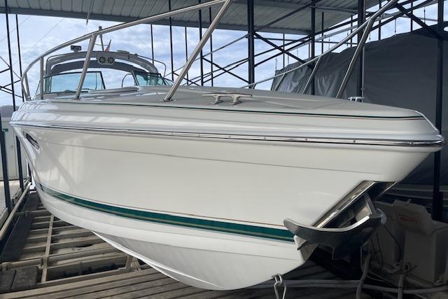 1999 Formula 400 Super Sport boat docked in a covered marina.