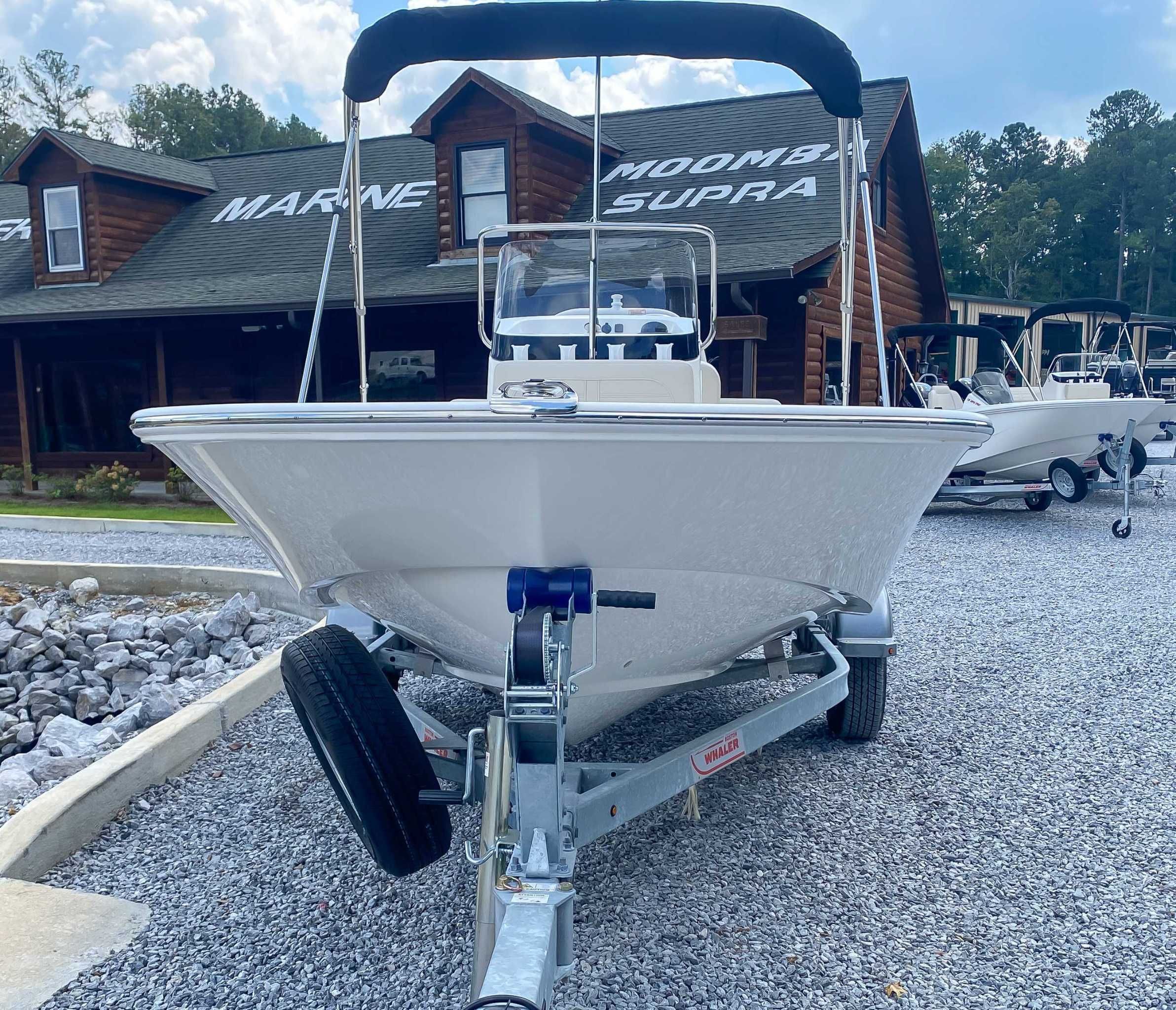 2025 Boston Whaler 170 Montauk on trailer in front of building.