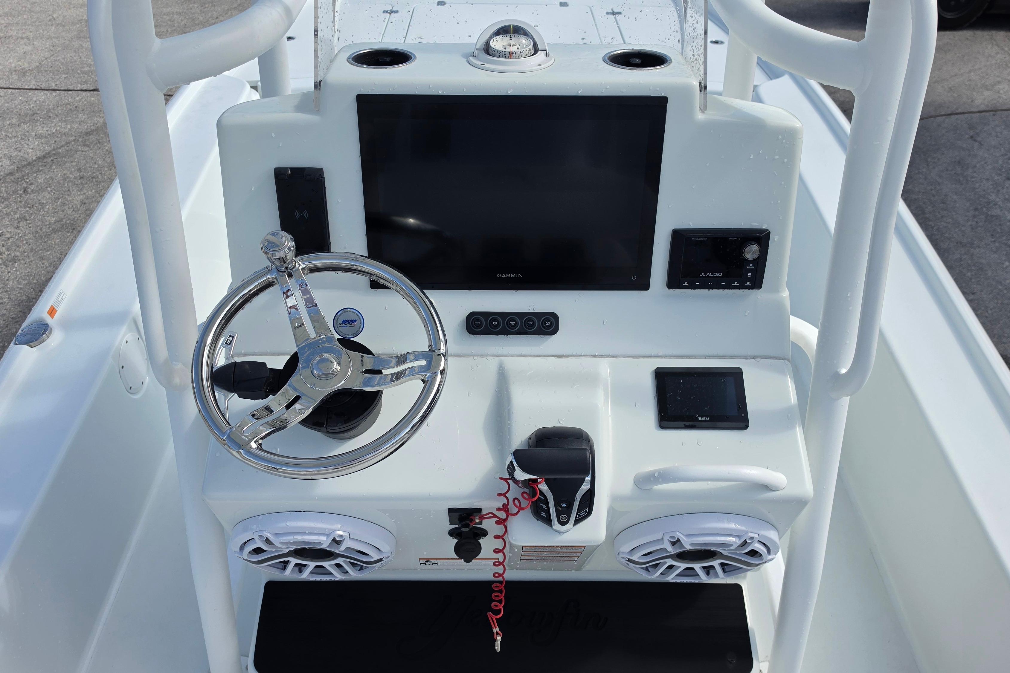2026 Yellowfin 24 Bay CE boat console with steering wheel and electronic displays.