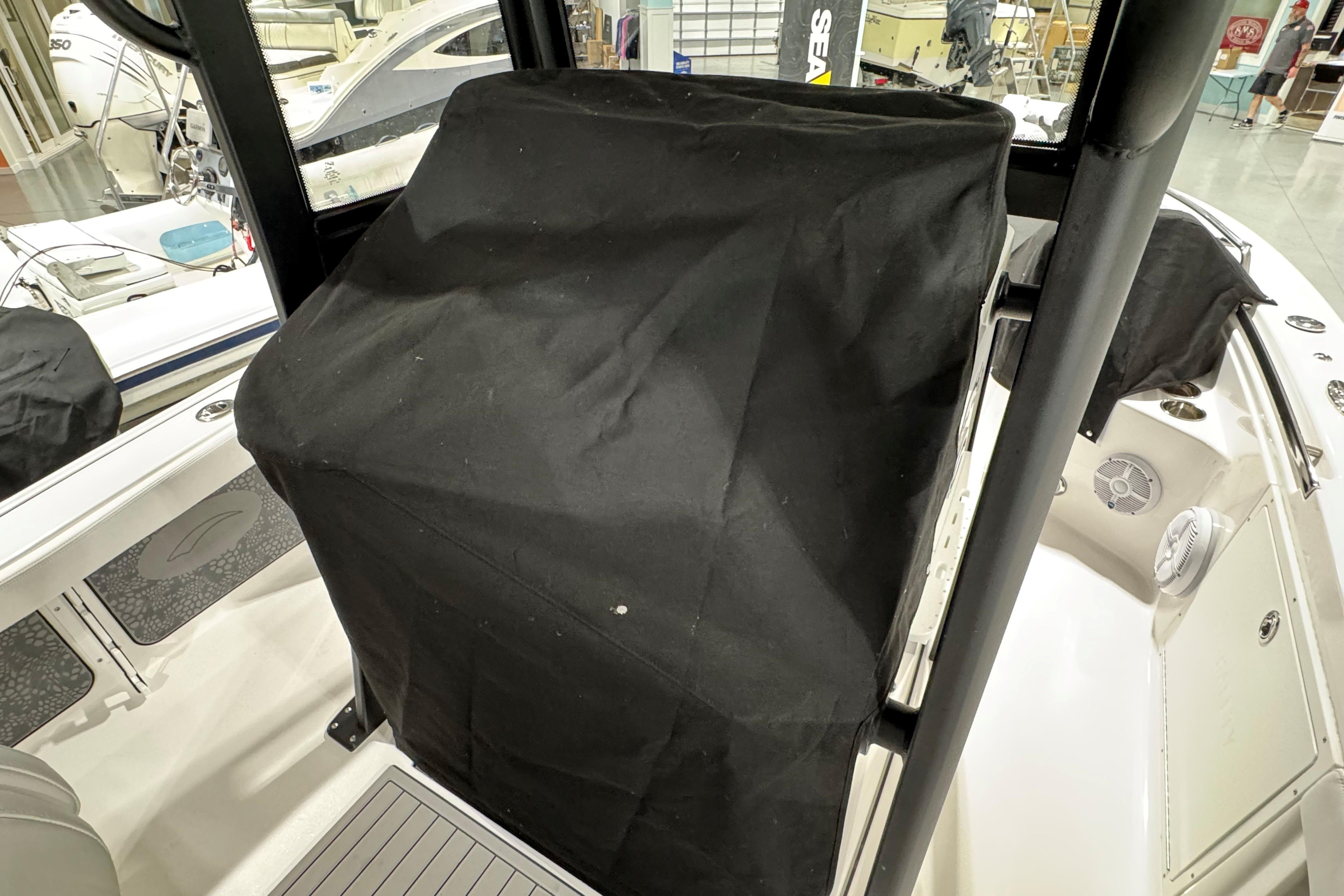 2025 Crevalle 24 HCO boat interior with covered console in a showroom.