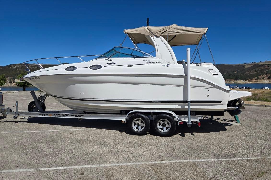 2004 Sea Ray Sundancer 260 boat on trailer, parked near a scenic lake.