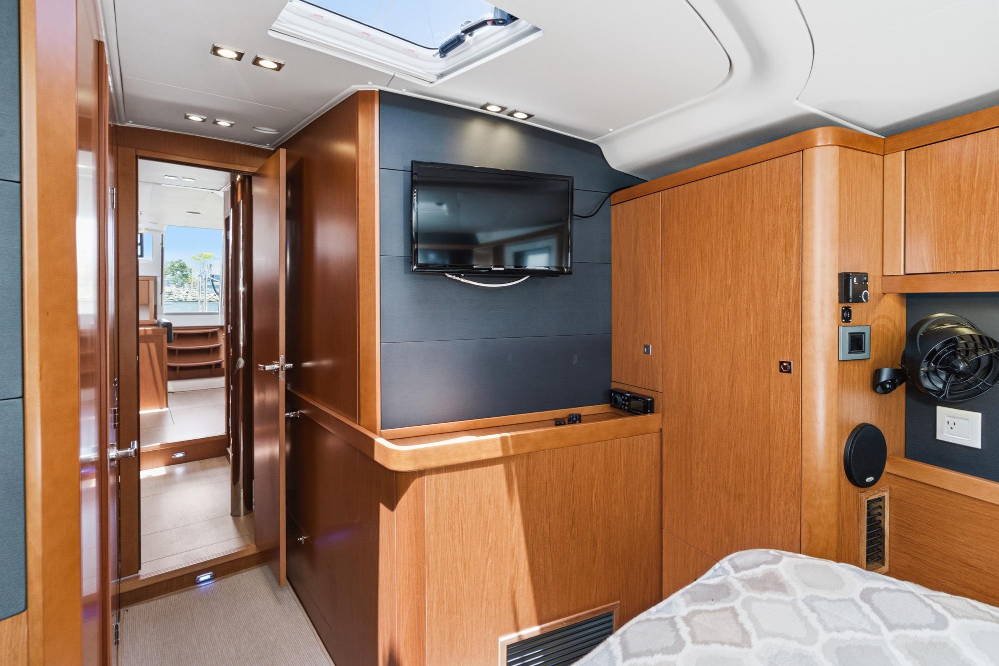 Interior of 2017 Beneteau Sense 50 yacht with wood paneling and mounted TV.