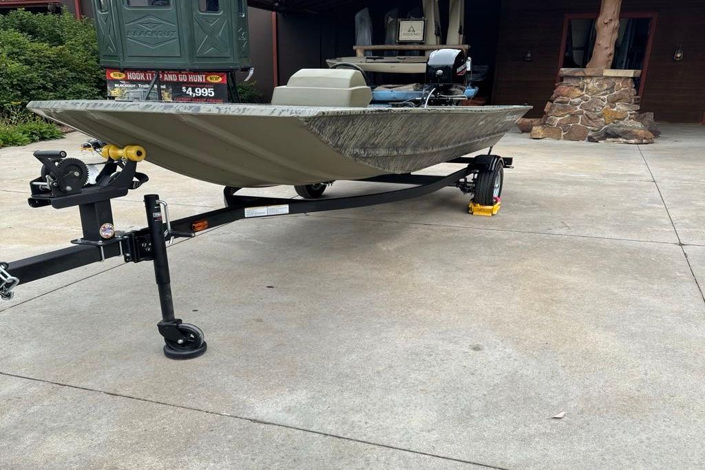 2026 Tracker Grizzly 1648 SC boat on trailer in driveway.