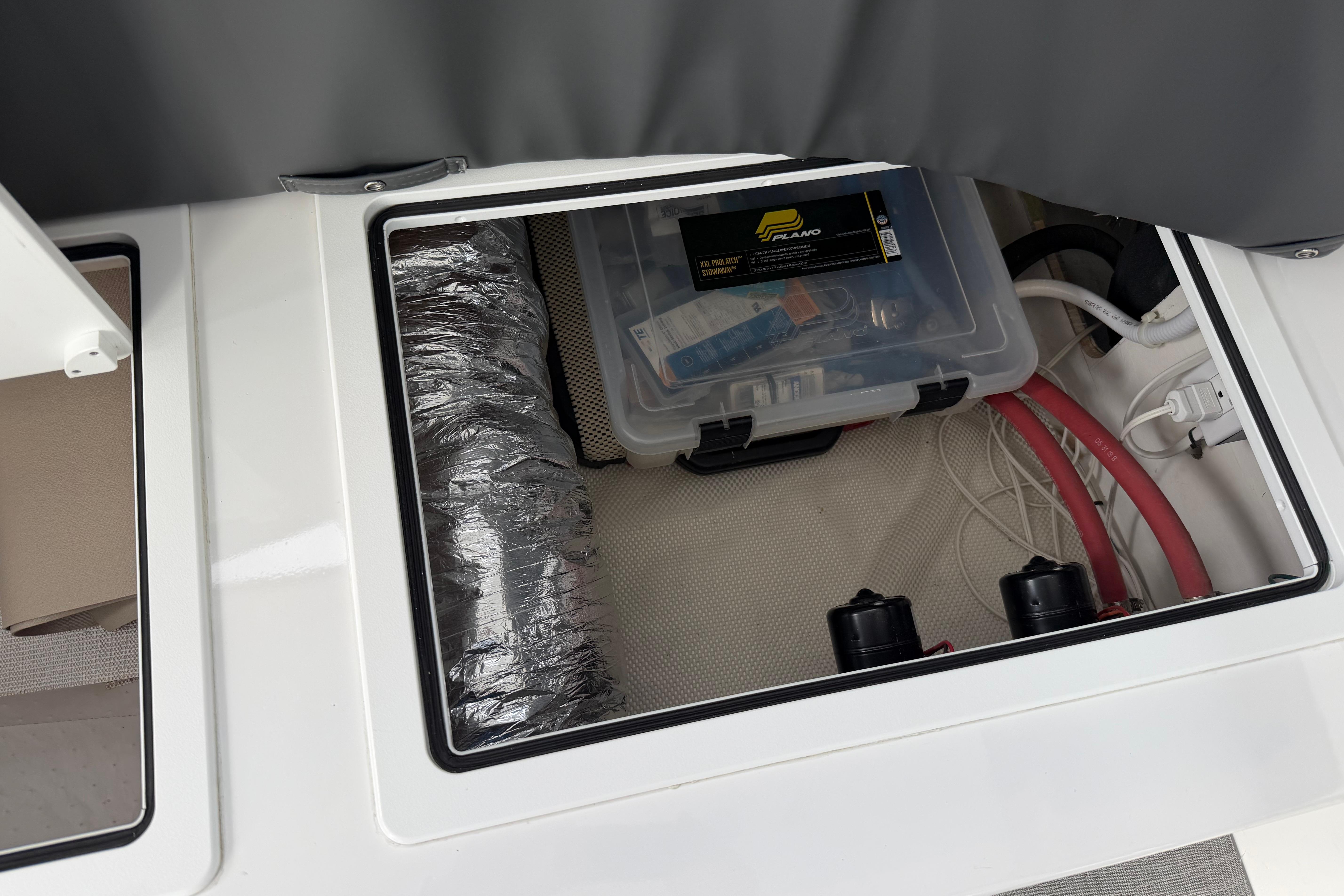 Storage compartment of 2018 H&H Marine Osmond Beal boat with tools and wiring.