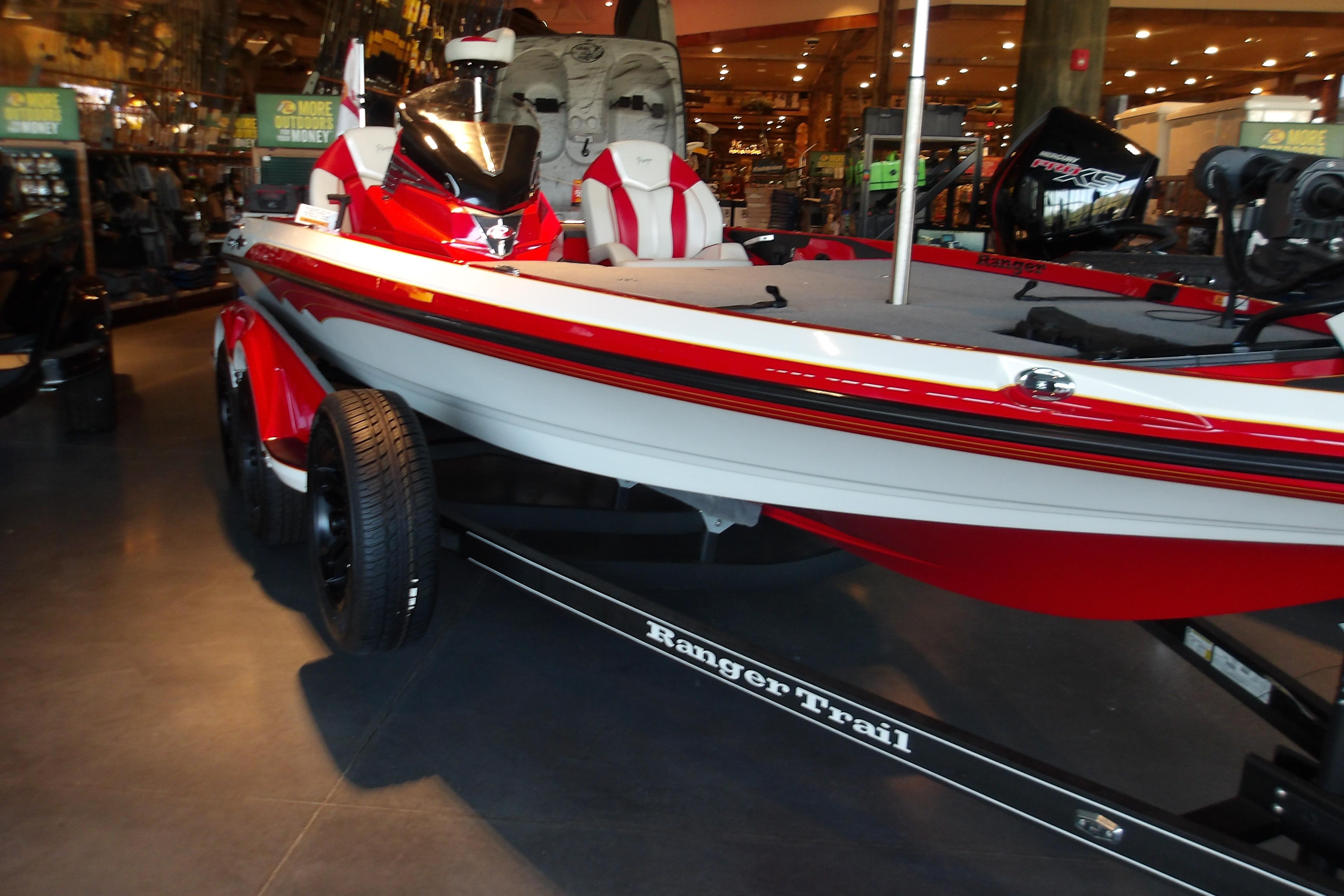 2025 Ranger Z519R Cup-Equipped boat displayed indoors, featuring sleek red and white design.