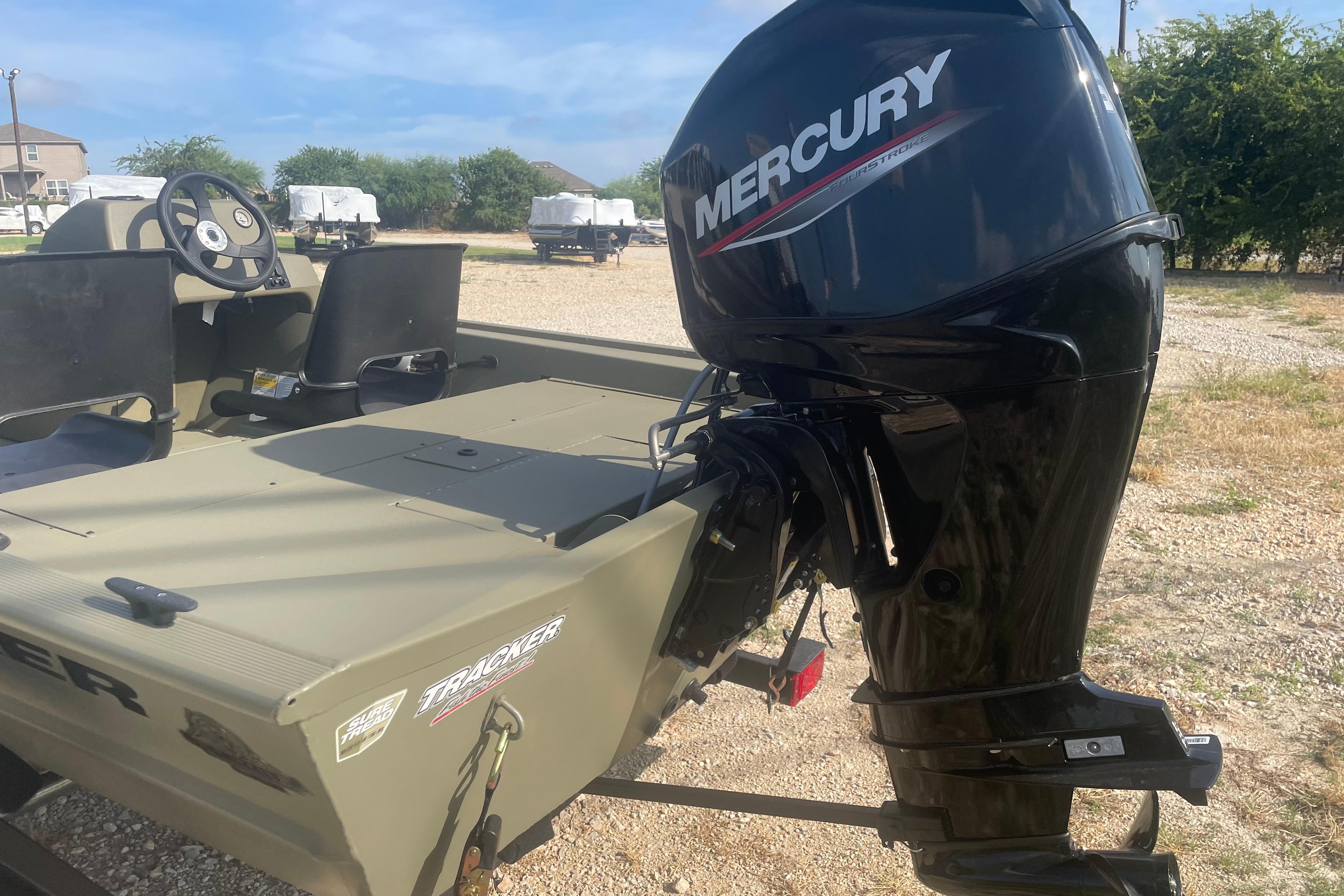2026 Tracker Grizzly 1754 SC boat with Mercury outboard motor in outdoor setting.
