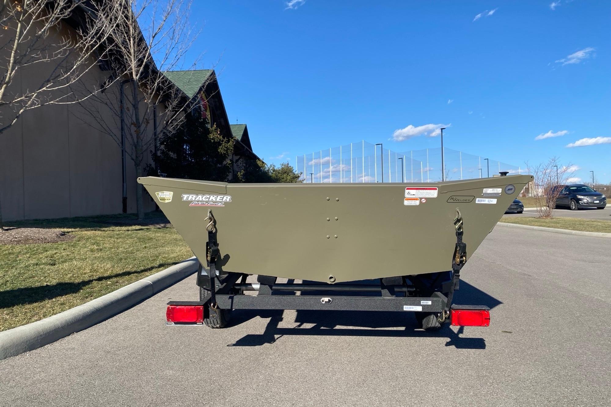 2026 Tracker Grizzly 1754 Utility boat on trailer, parked outdoors under clear blue sky.