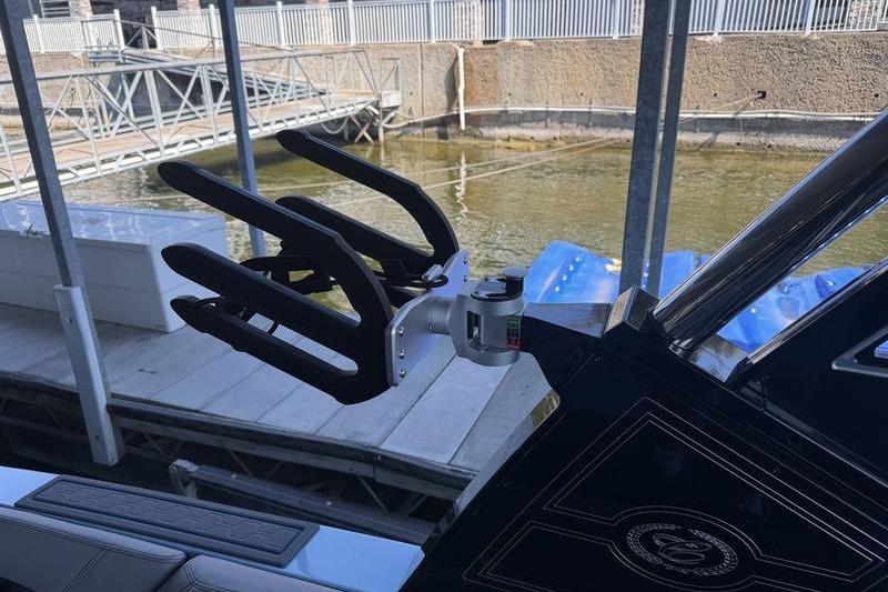 2026 Cobalt R8 Surf boat with wakeboard rack at dockside.