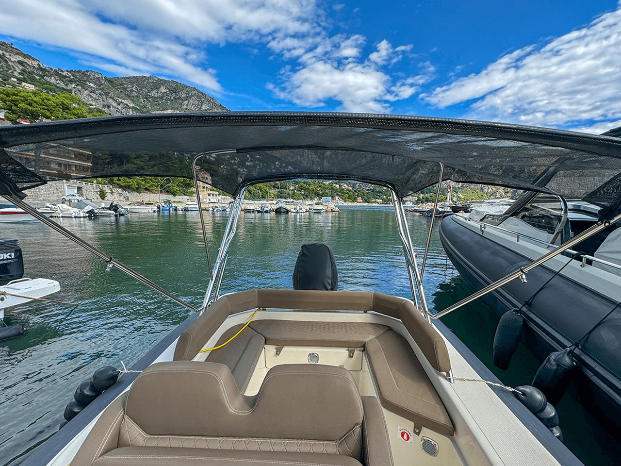 BSC 78 boat from 2019 docked in a scenic marina with mountains.