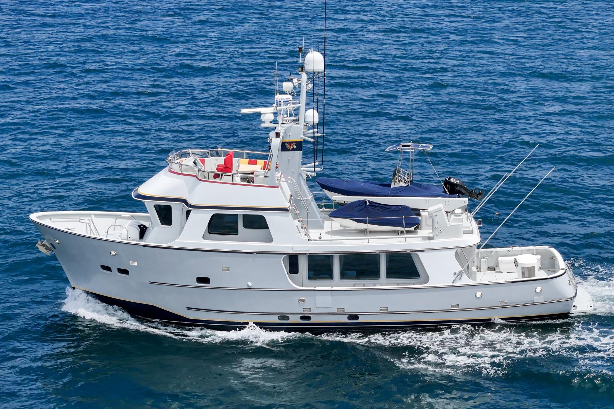 Seaton Long Range Cruiser 1990 navigating on open sea, showcasing sleek design and spacious deck.