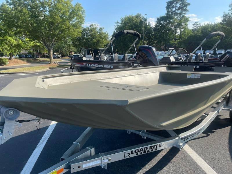 2025 Tracker GRIZZLY 2072 Utility boat on Load Rite trailer in parking lot.