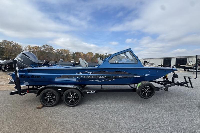 2026 SeaArk Dynasty 2.0 boat on trailer, blue exterior, parked outdoors.