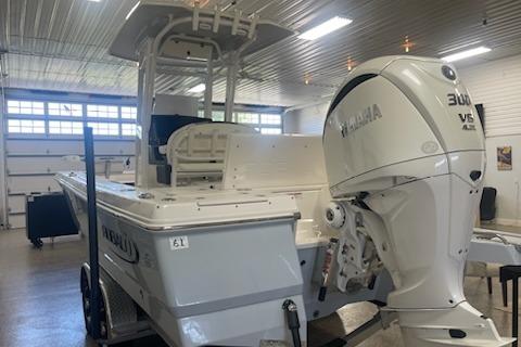 2024 Robalo 246 Cayman boat with Yamaha 300 V6 engine in a showroom.