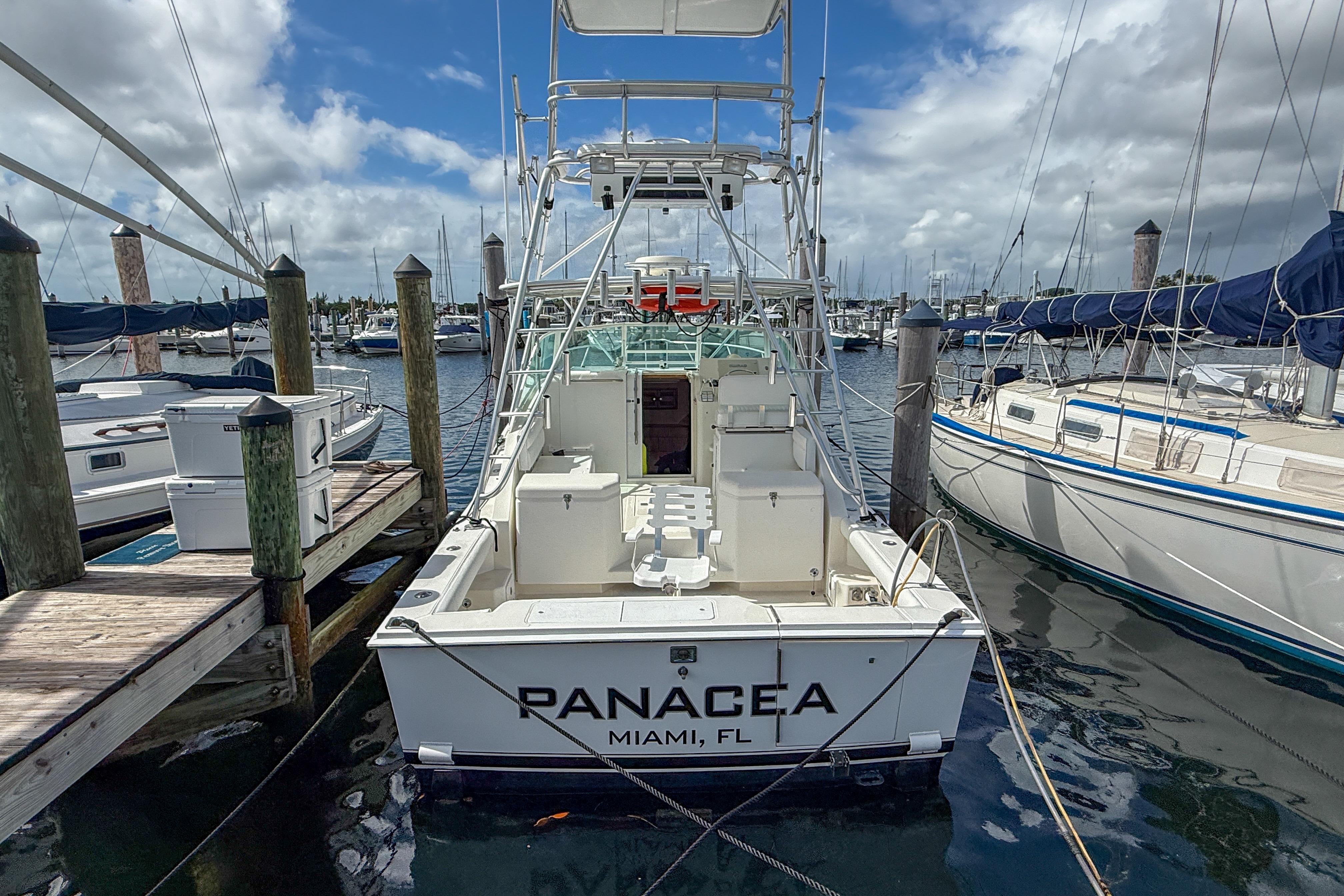 1998 Cabo 31 Express boat docked at marina, named "Panacea," Miami, FL.