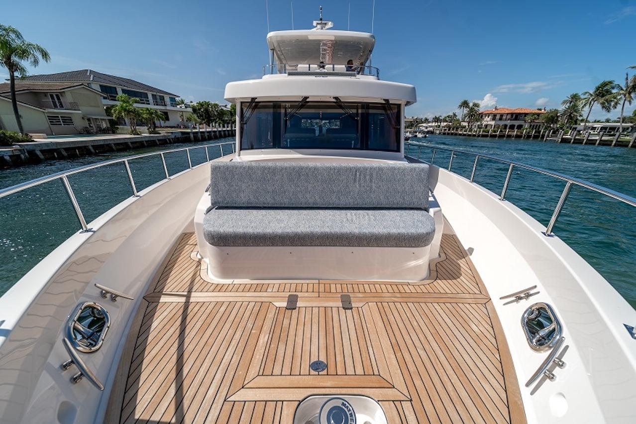 Luxurious 2027 Offshore Yachts 70 CE with spacious deck and waterfront view.