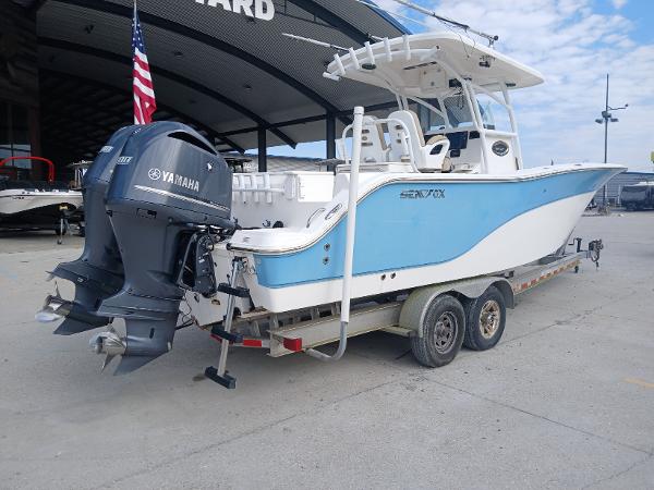 2015 Sea Fox 286 Commander boat on trailer with Yamaha engines, parked outdoors.