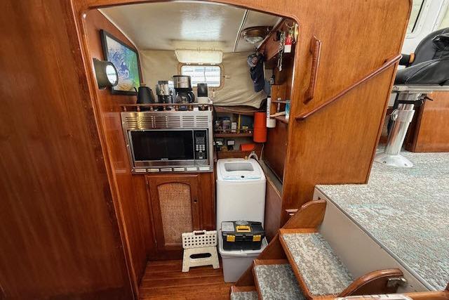 Interior of 1982 Lancer 45 Motorsailer with microwave, washing machine, and wooden cabinetry.