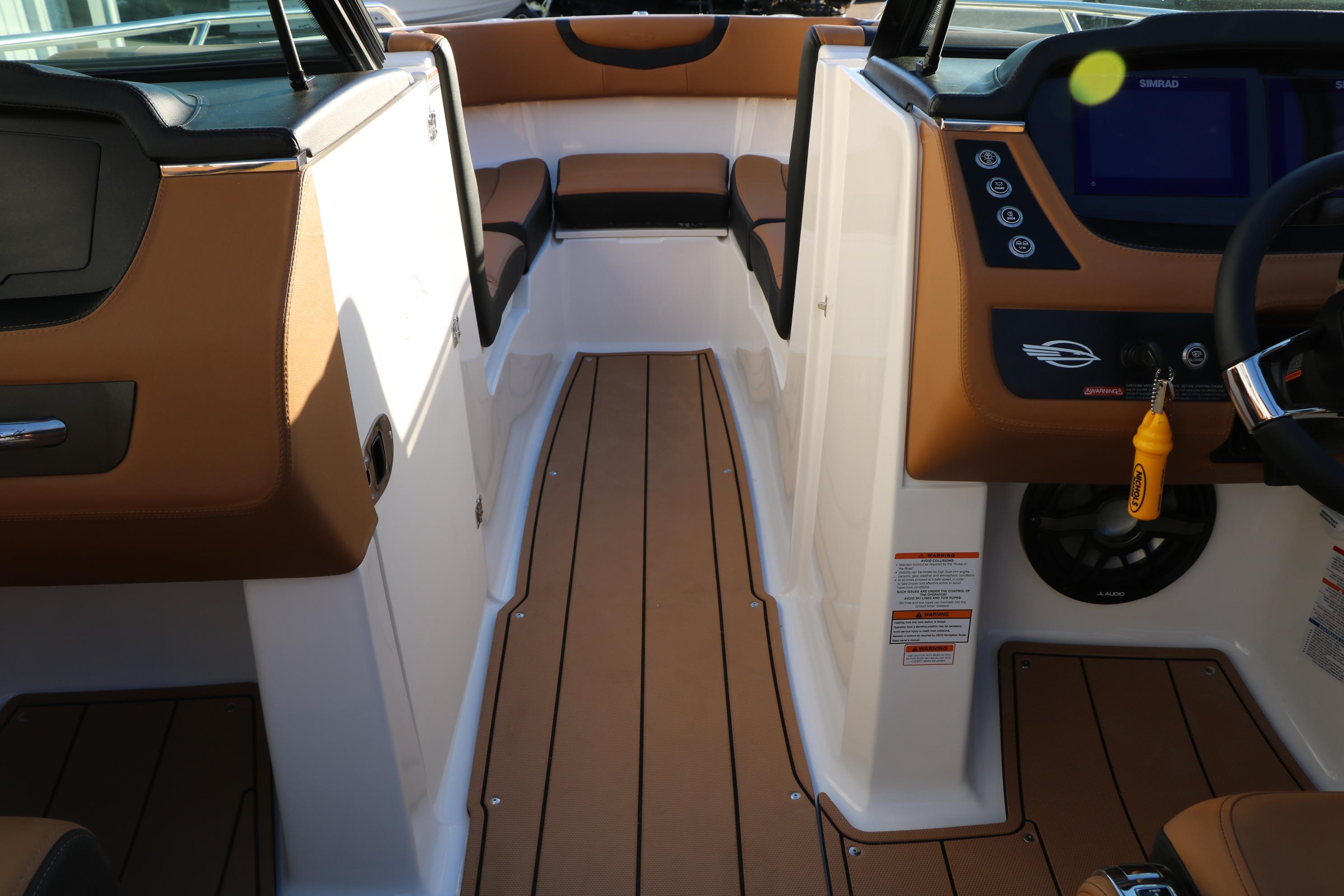 2026 Chaparral 247 SSX boat interior with brown seating and modern dashboard.