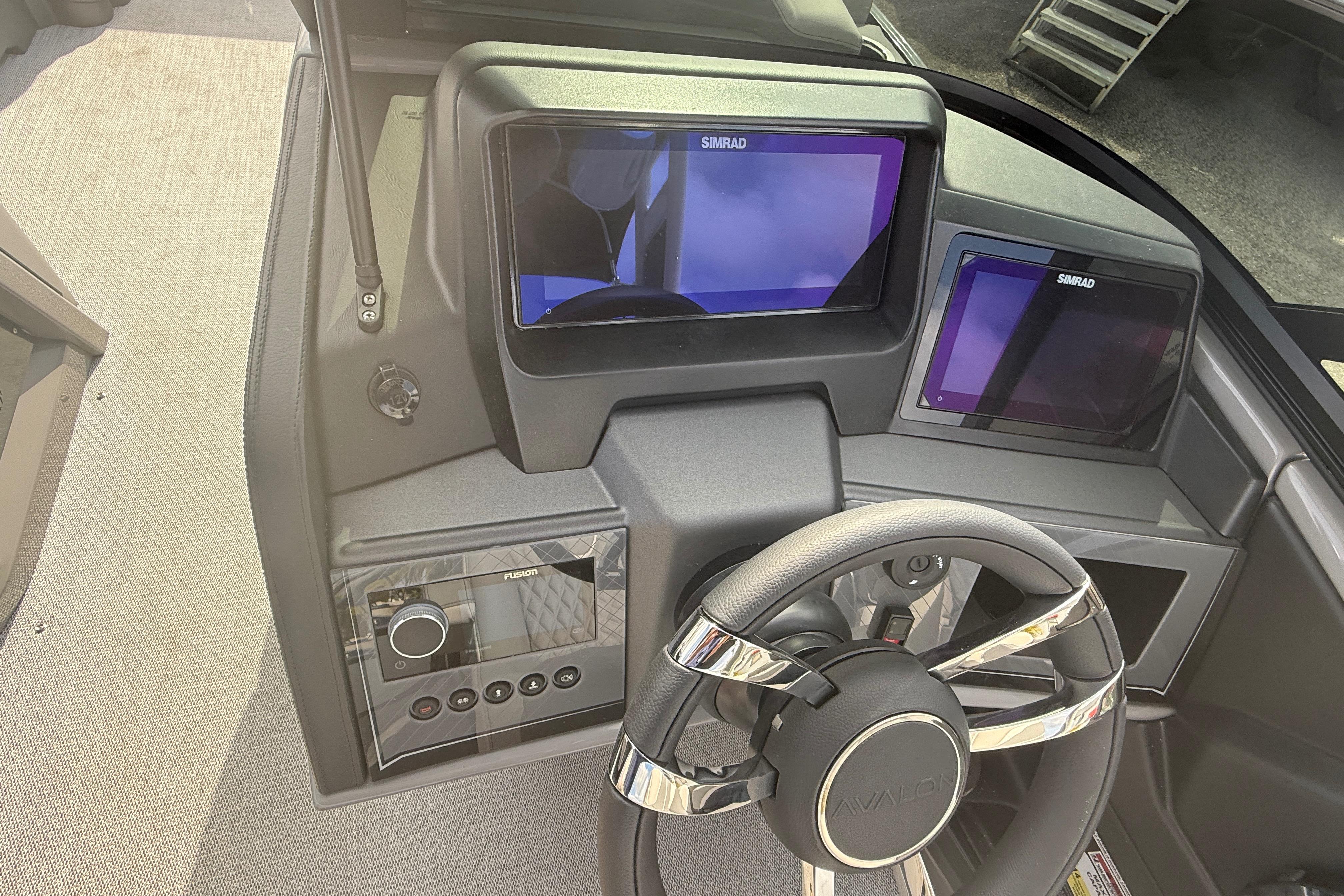 Dashboard of 2026 Avalon 2585 Excalibur LTD with Simrad displays and steering wheel.