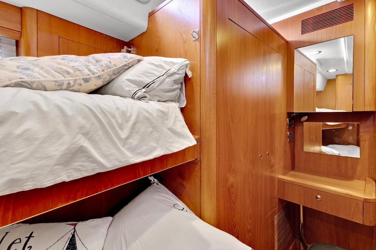 Cozy cabin interior of 2011 Southerly 57 RS yacht with wooden finish and bunk beds.