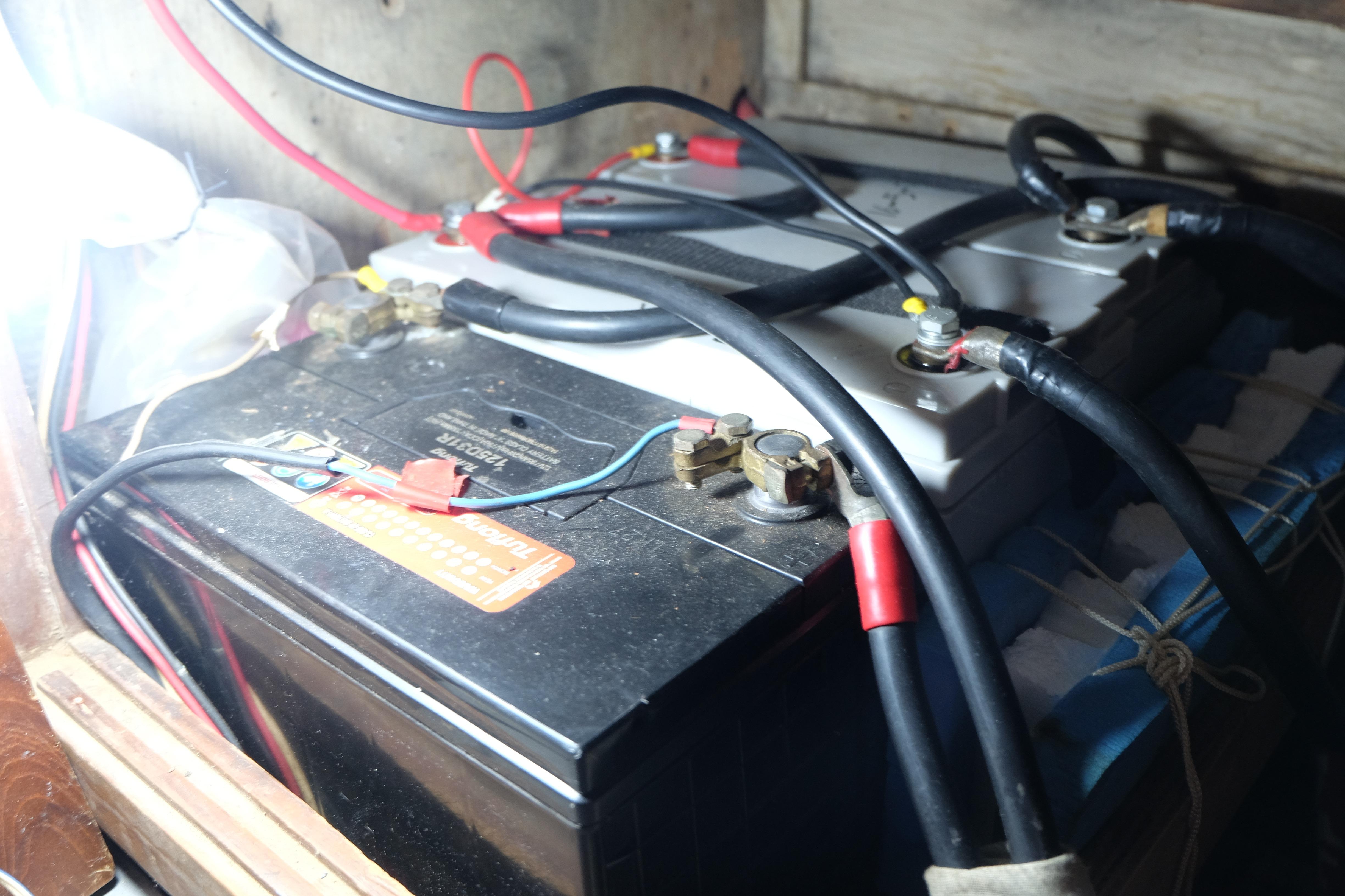 Battery setup in a 1979 Westwind 35, featuring cables and connections.