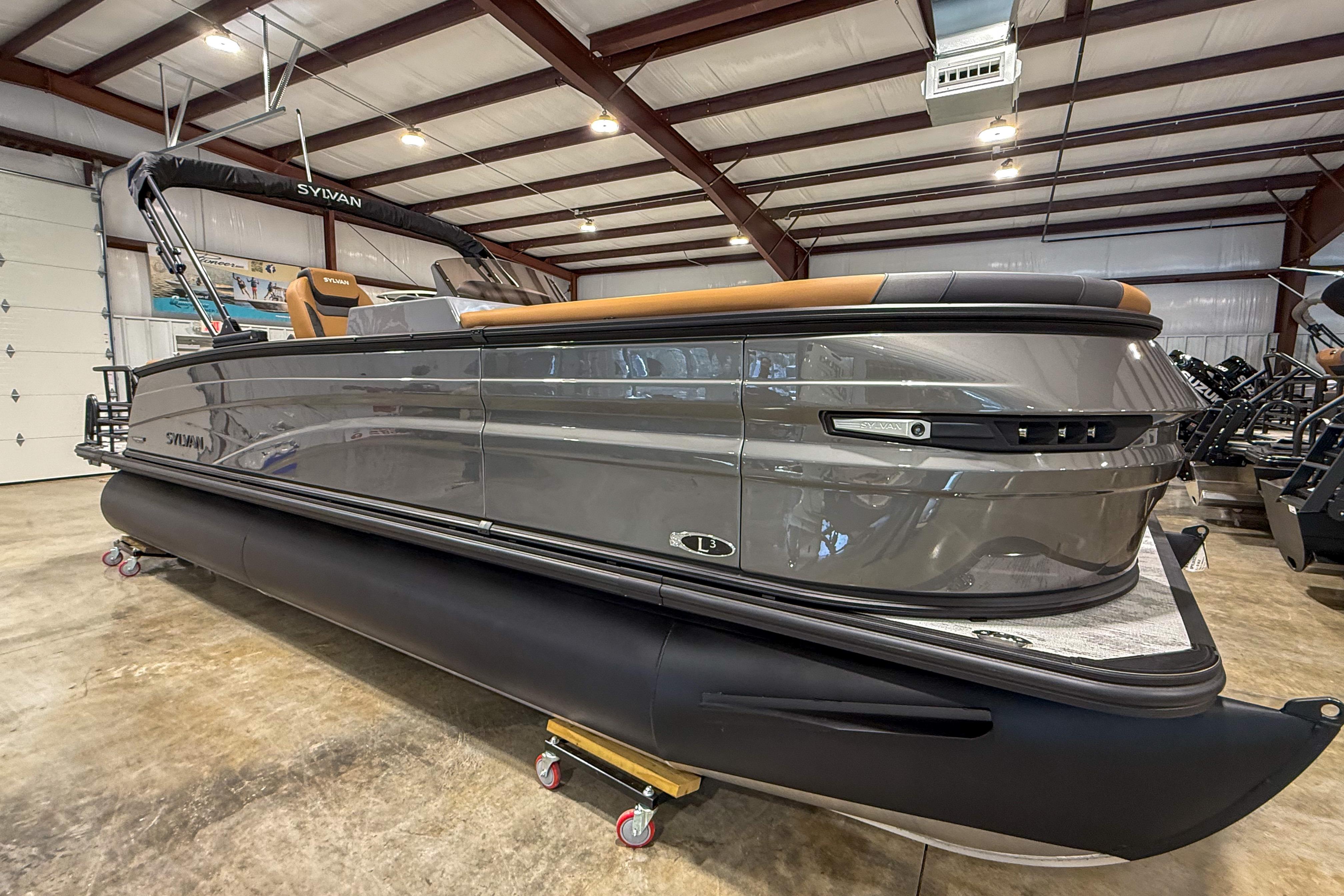 2026 Sylvan L3 LZ DH pontoon boat in a showroom, showcasing sleek design and modern features.