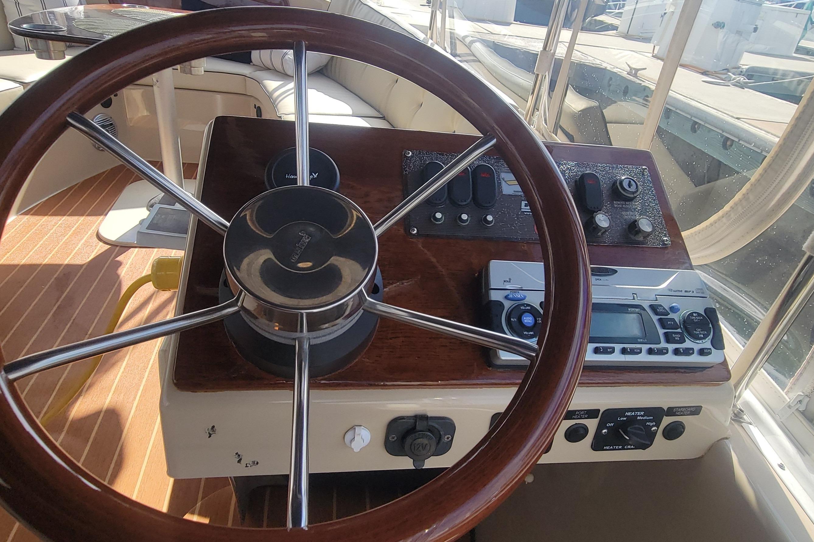 Steering wheel and controls of a 2008 Duffy Snug Harbor 18 boat.