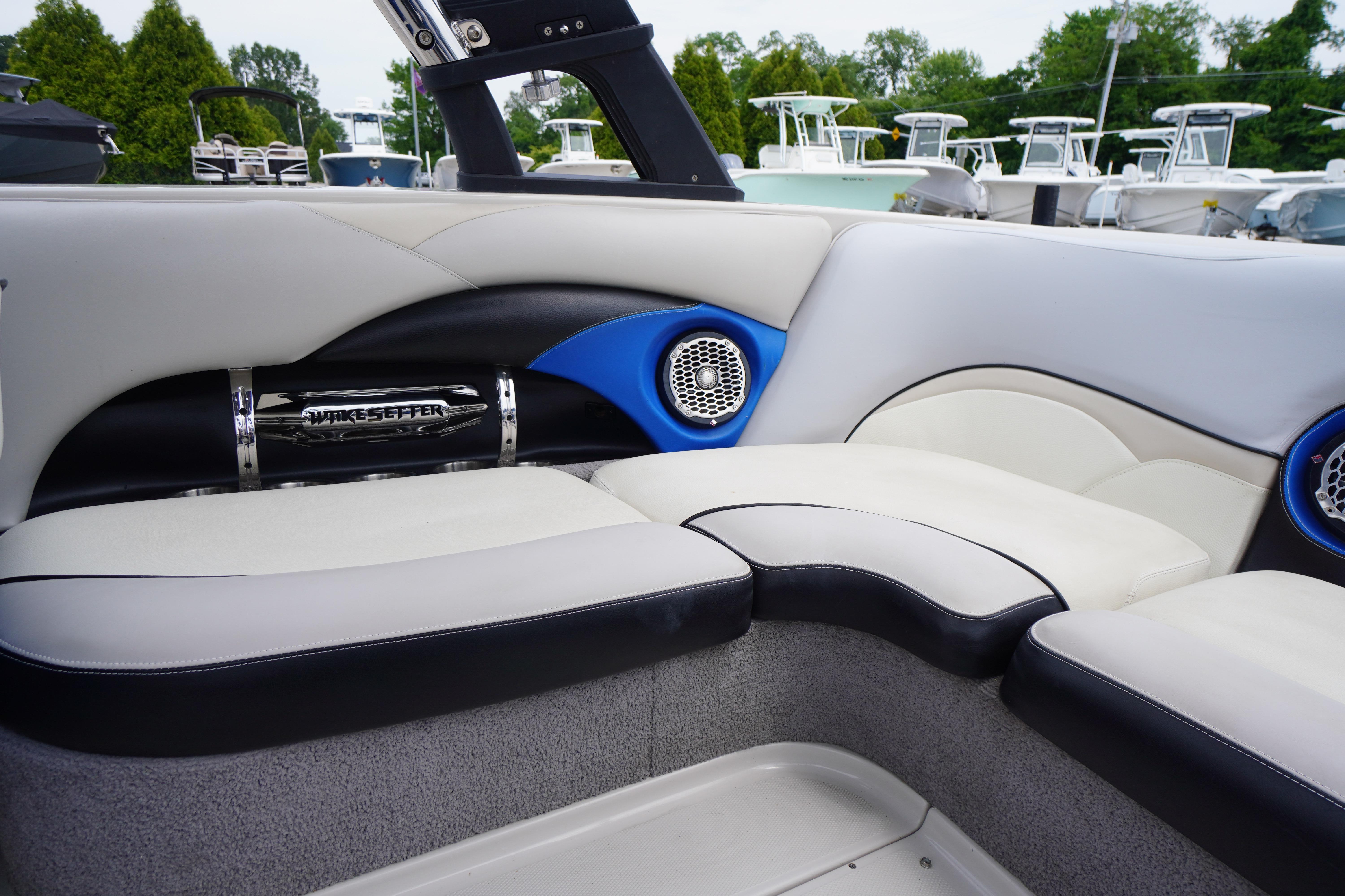 Interior of 2011 Malibu Wakesetter 21 VLX boat with stylish seating and speakers.