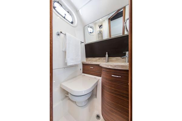 Manufacturer Provided Image: 2018 Pursuit S 368 Sport boat bathroom with modern fixtures and wood accents.