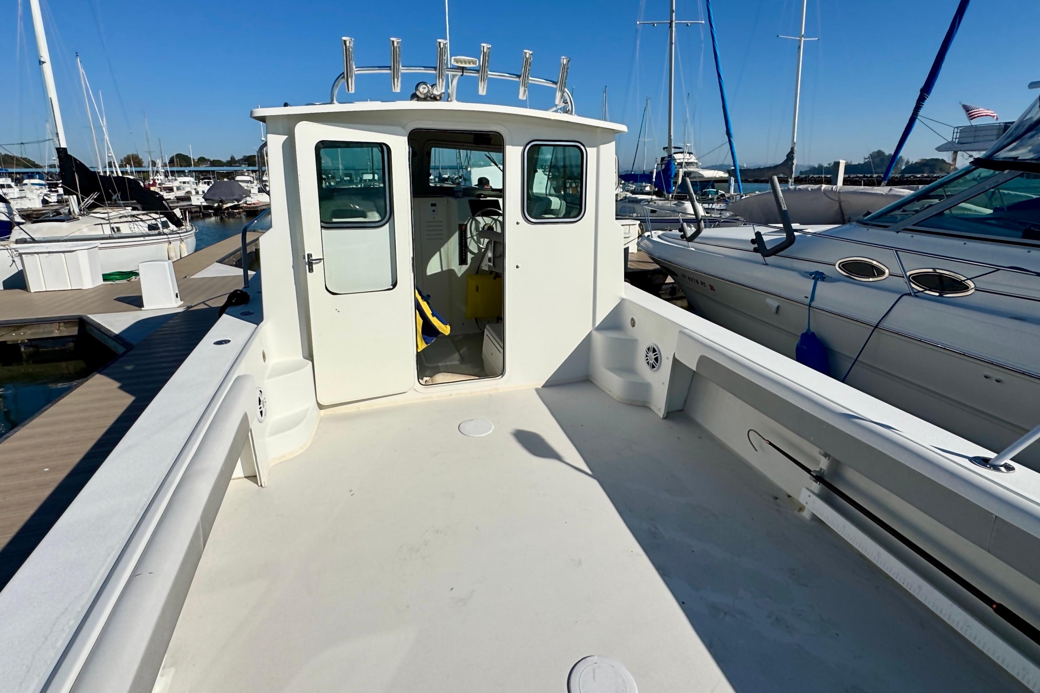 2021 Parker 2820 XLD Sport Cabin boat docked at marina, showcasing spacious deck and cabin.