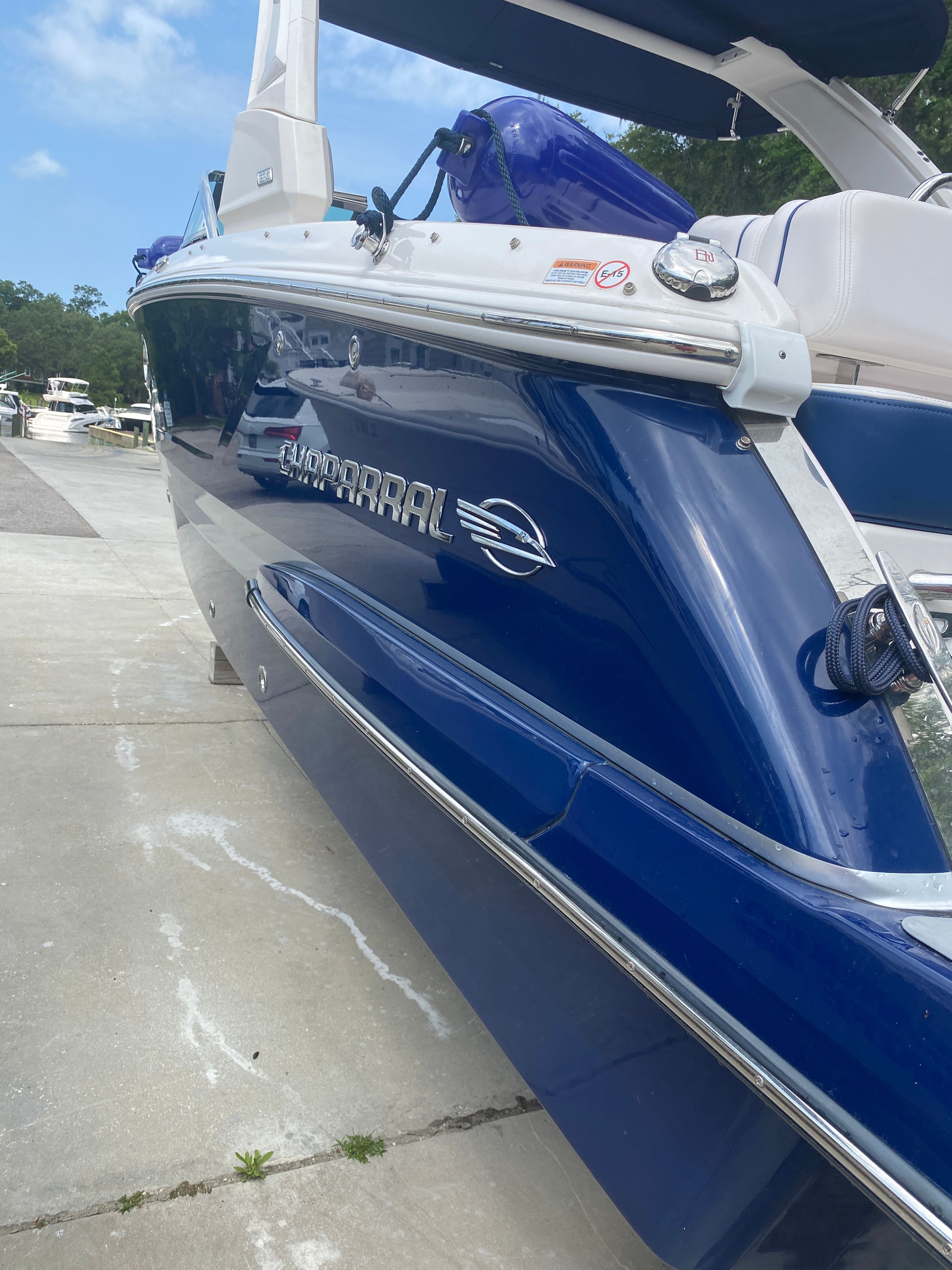 Blue 2020 Chaparral 256 SSX boat docked on concrete.