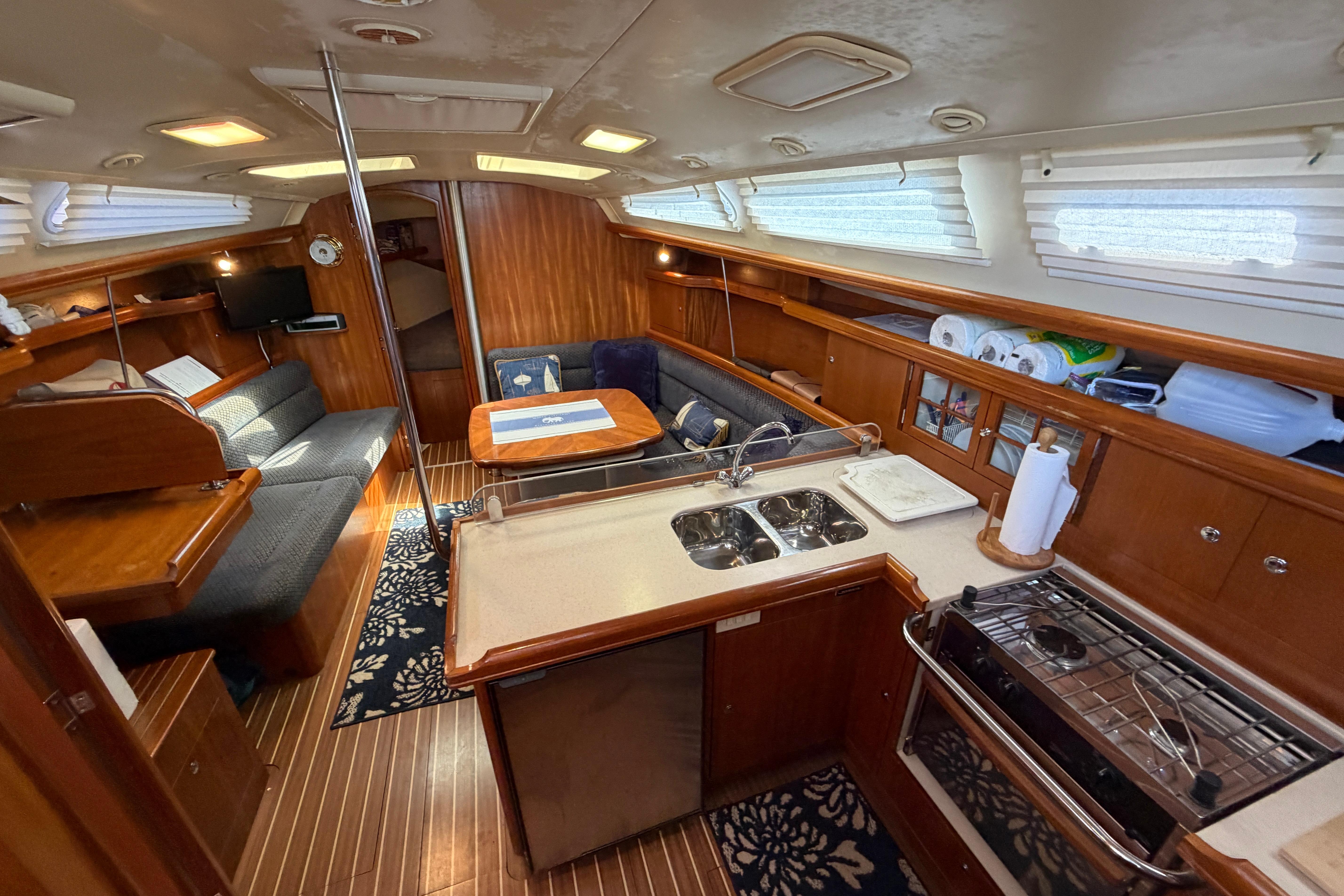 Interior of a 2005 Hunter 38 sailboat with kitchen and seating area.