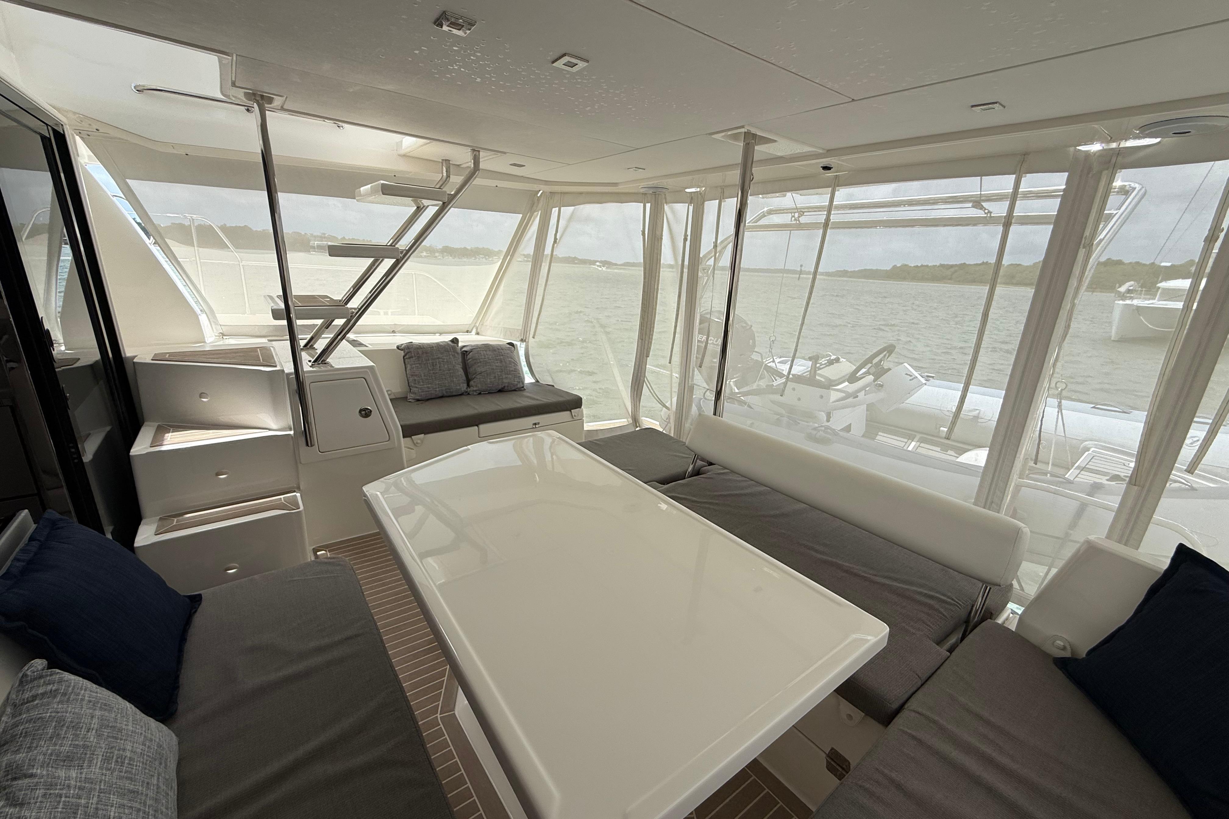 Interior of 2021 Leopard 43 Powercat yacht with spacious seating and table.