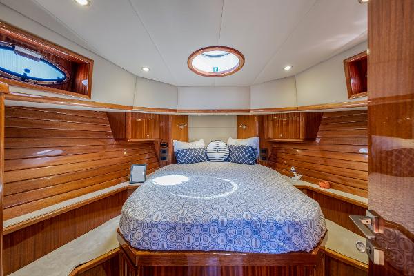 Luxurious cabin interior of 2023 Vento V40 Retro Classic Open yacht with wood paneling and cozy bed.