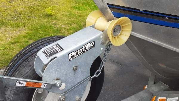 Boat trailer with yellow roller holder and chain.